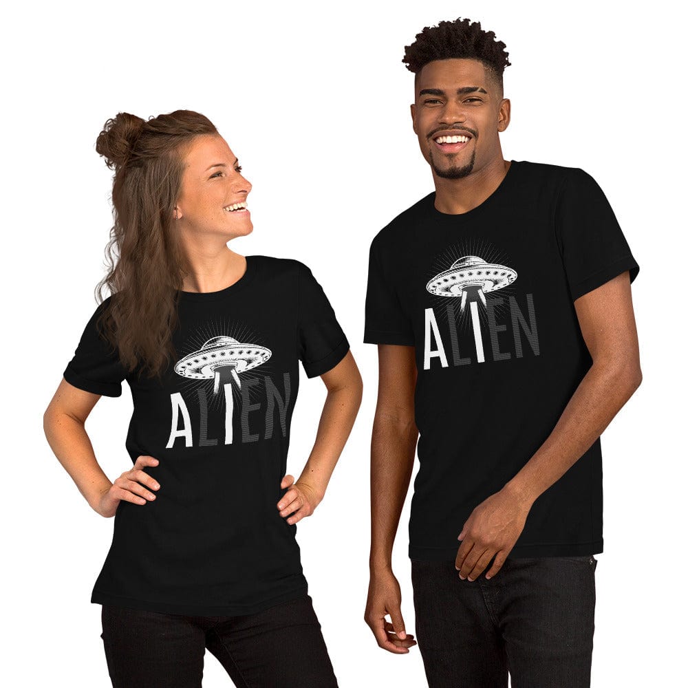 A smiling man and woman both wearing matching black "ALIEN" t-shirts with a UFO graphic and block-letter text, highlighting "AI" giving off a playful, coordinated style.