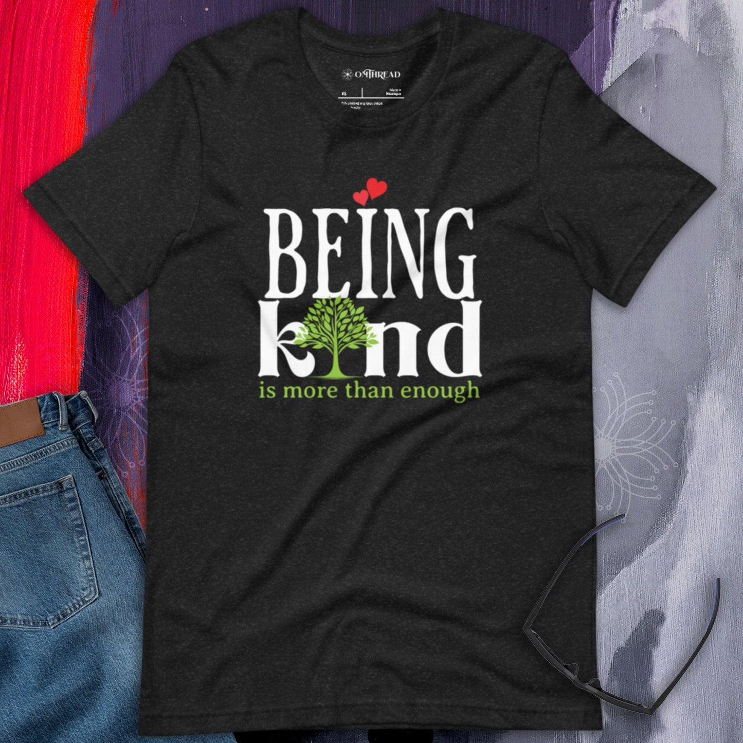 OMTHREAD black heather t-shirt with "BEING kind is more than enough" design featuring a tree with hearts.
