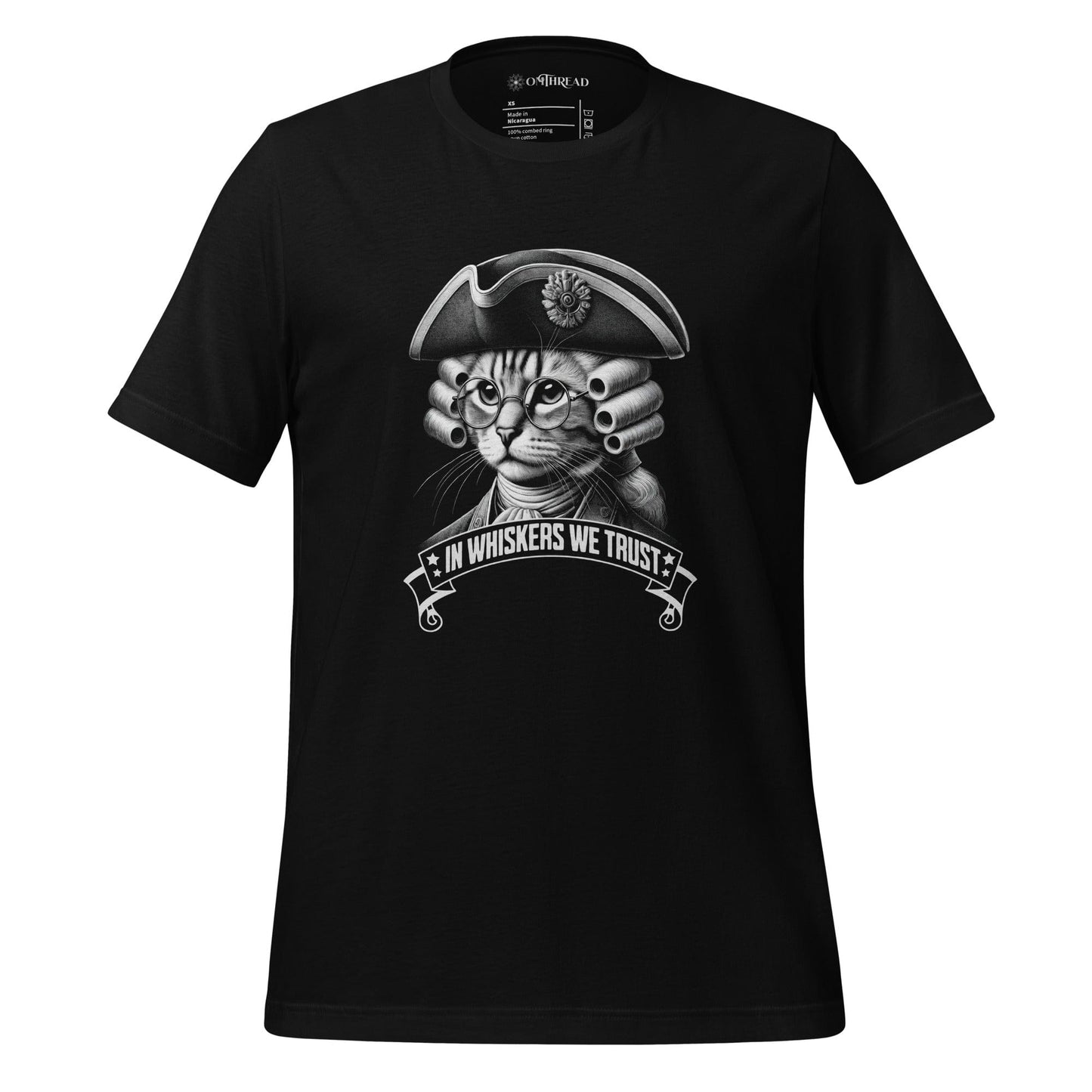 OMTHREAD black t-shirt featuring a detailed cat illustration dressed in colonial attire, wearing a tricorn hat, glasses, and a powdered wig. The design includes the phrase 'In Whiskers We Trust' in a bold banner.