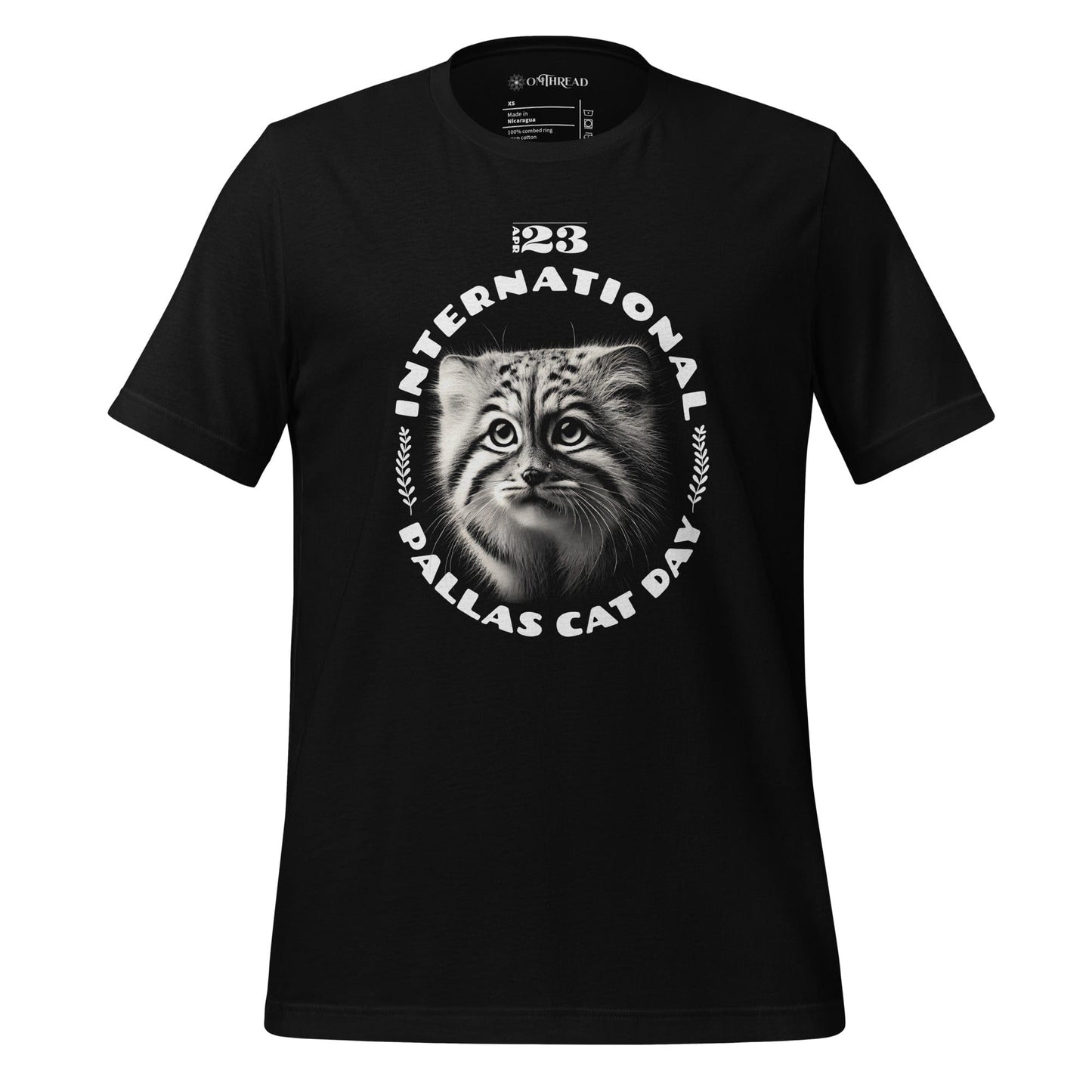 OMThread black t-shirt featuring a black-and-white illustration of a Pallas cat kitten inside a circular design with the text "International Pallas Cat Day" and the date "April 23" above.