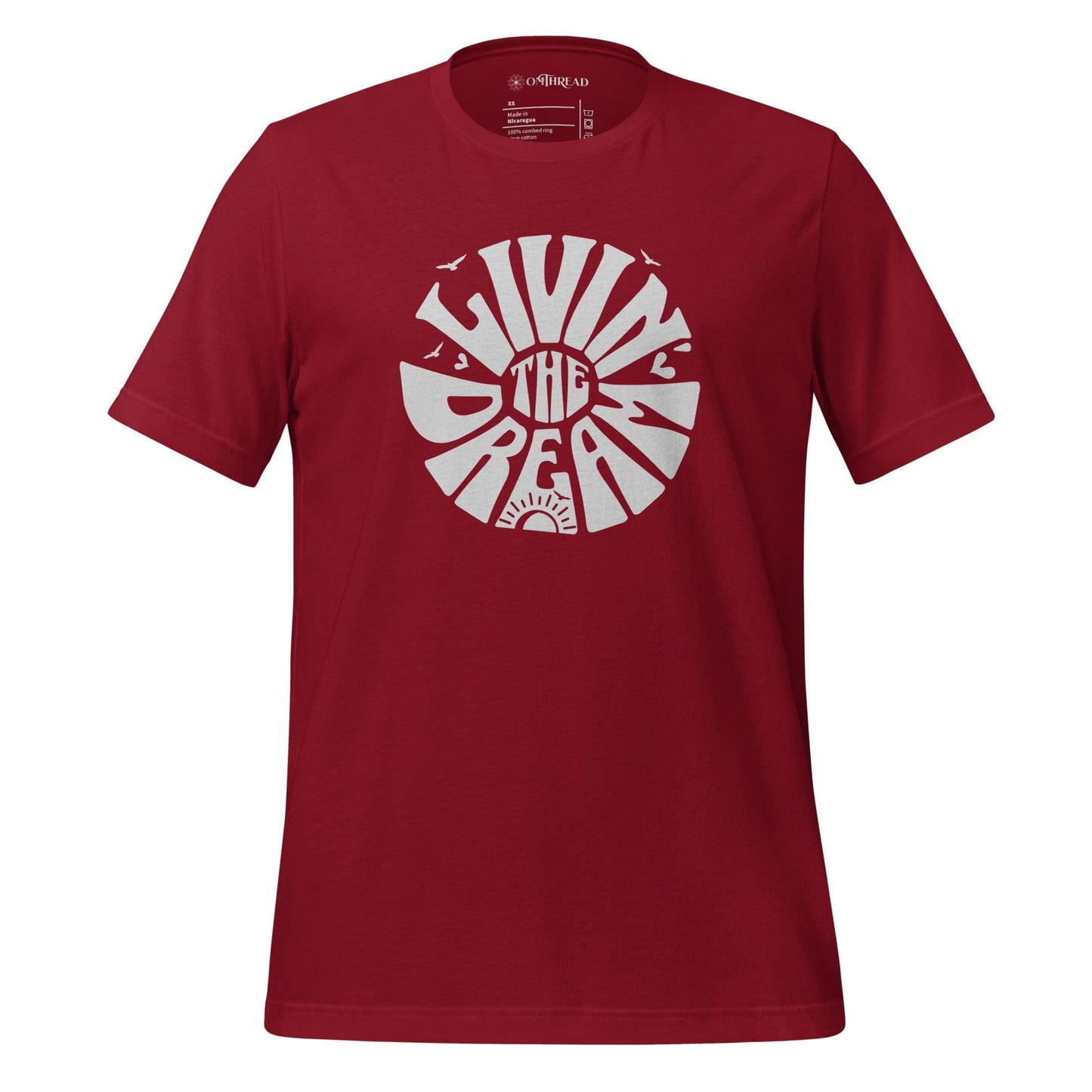 OMTHREAD red t-shirt featuring white retro-style typography reading "Livin' the Dream" in a circular design with sun, birds, and heart elements.