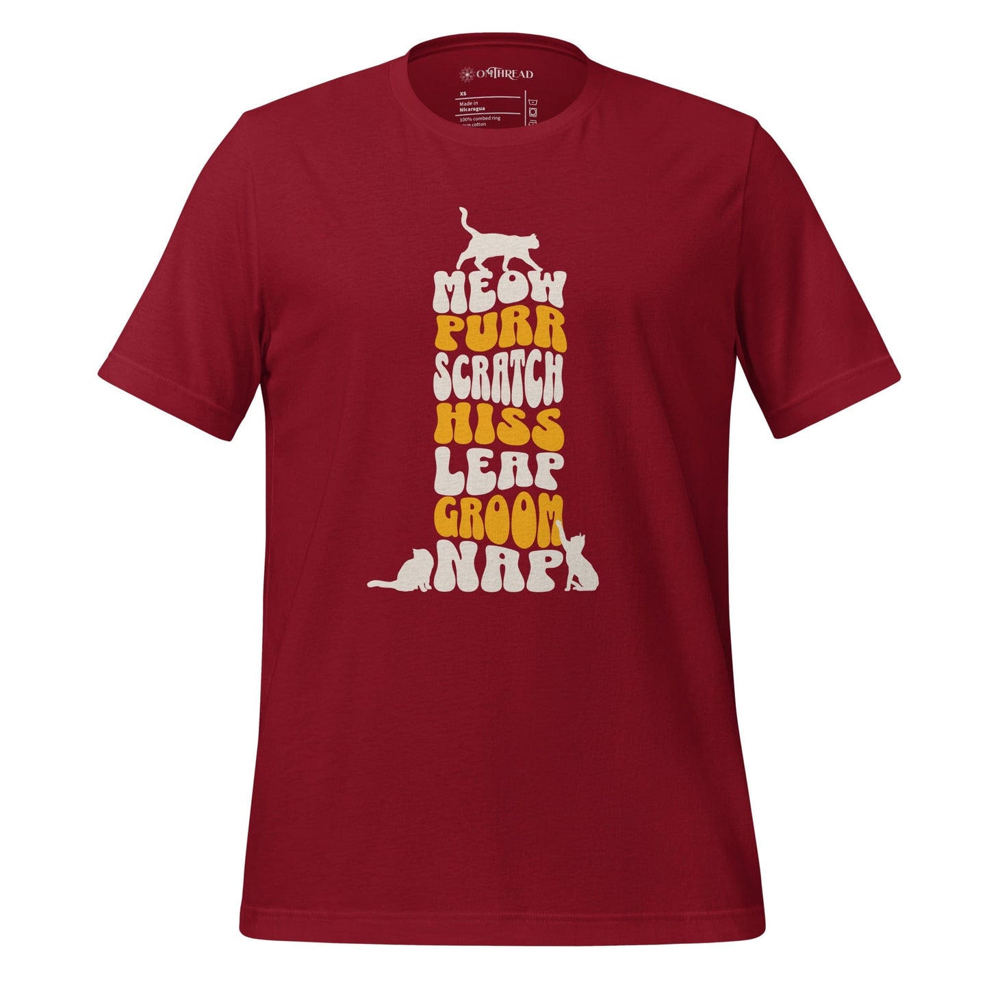 OMTHREAD red t-shirt featuring a vertical stack of bold, playful typography with the words meow, purr, scratch, hiss, leap, groom, and nap. Small cat silhouettes accent the top and bottom of the text.