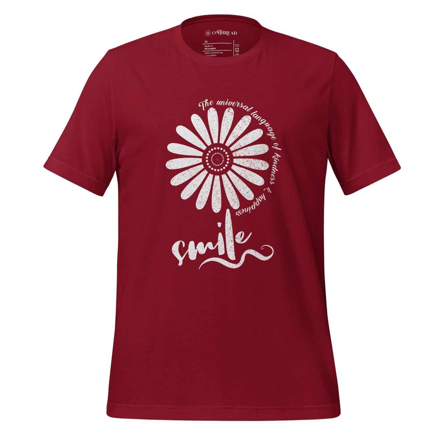OMTHREAD cardinal red t-shirt with a white floral design and the word "smile" in script, surrounded by the phrase "The universal language of kindness & happiness" in a circular pattern