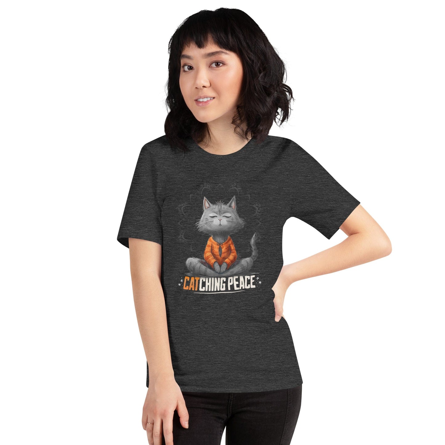 Dark gray t-shirt featuring a meditating cat in a peaceful lotus pose, surrounded by a mandala-inspired design. Below the cat, the text reads 'Catching Peace' in bold typography. Ideal for yoga lovers, mindfulness seekers, and cat enthusiasts.