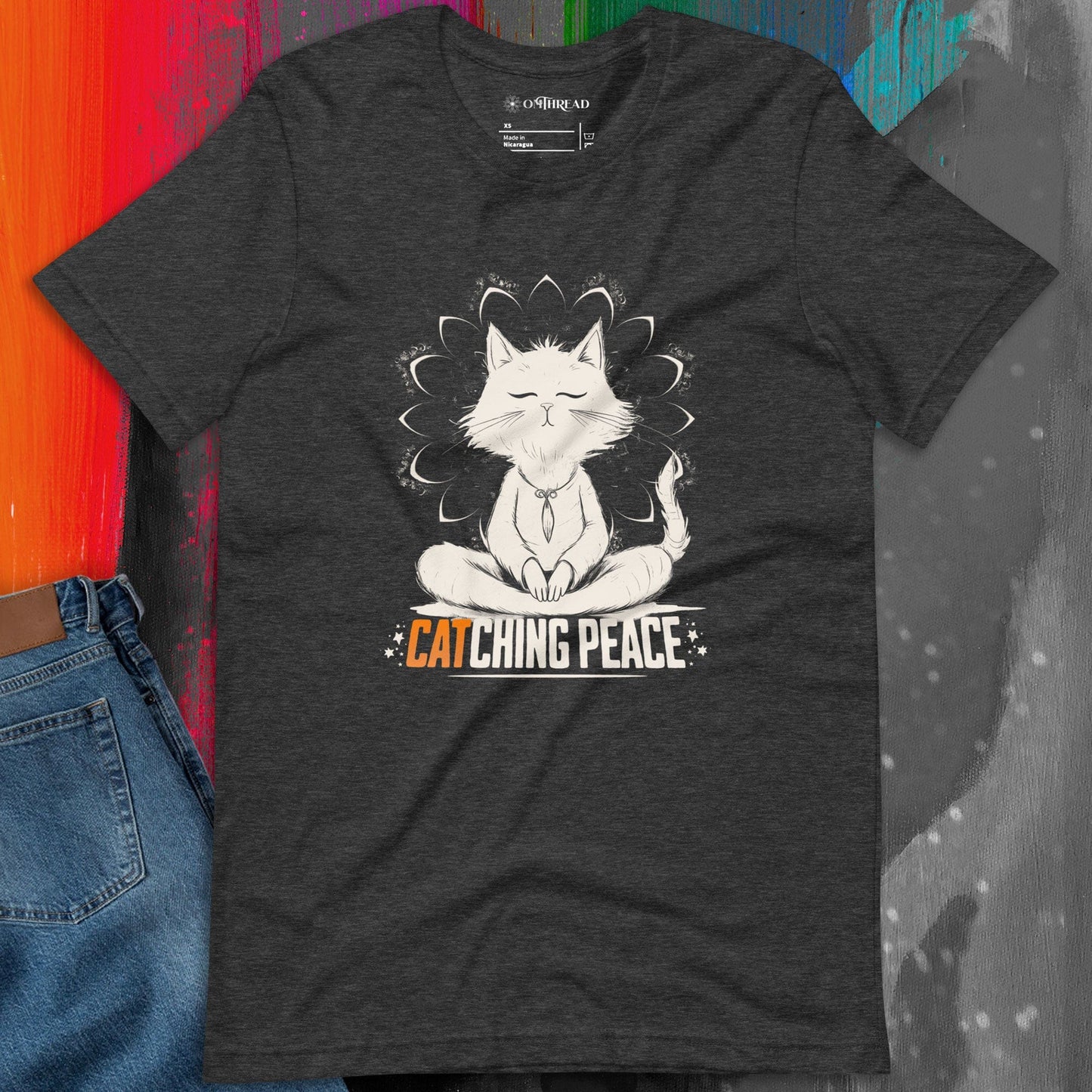 Dark Gray t-shirt featuring a meditating cat in a peaceful lotus pose, surrounded by a mandala-inspired design. Below the cat, the text reads 'Catching Peace' in bold typography. Ideal for yoga lovers, mindfulness seekers, and cat enthusiasts.