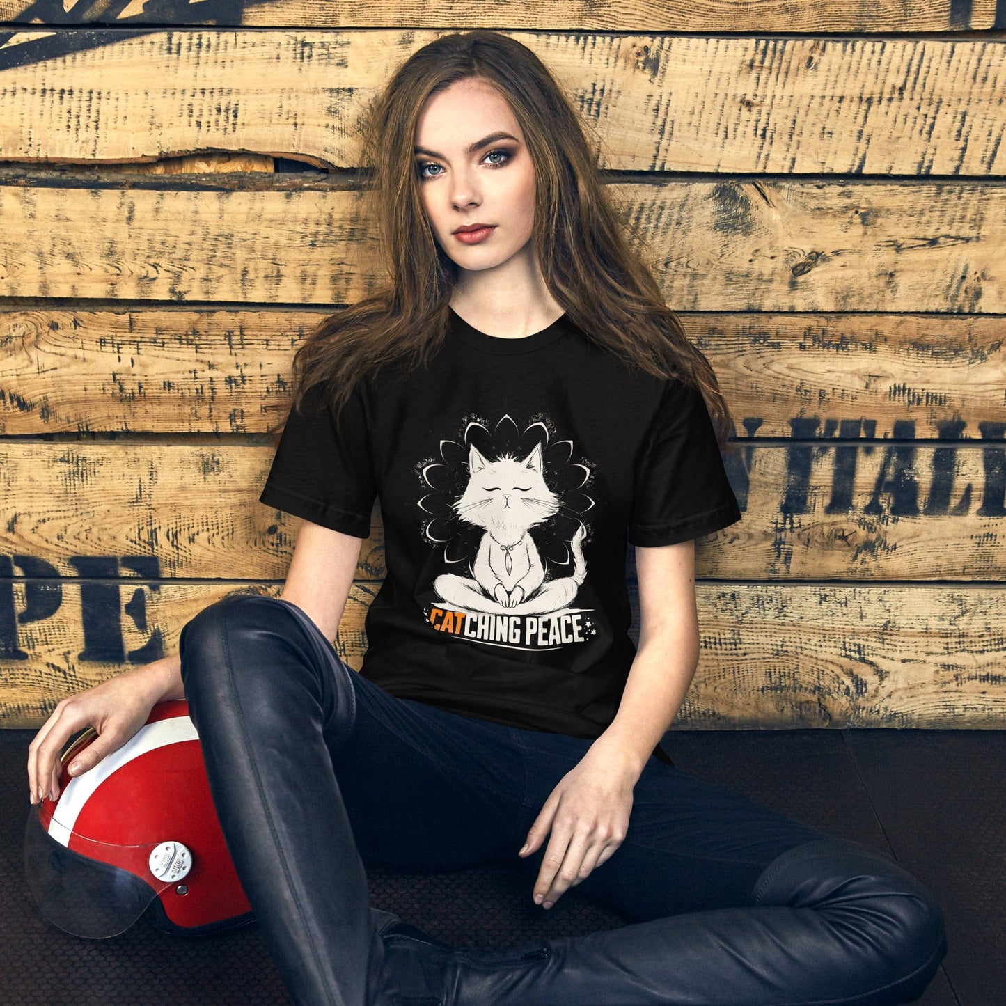 Black t-shirt featuring a meditating cat in a peaceful lotus pose, surrounded by a mandala-inspired design. Below the cat, the text reads 'Catching Peace' in bold typography. Ideal for yoga lovers, mindfulness seekers, and cat enthusiasts.