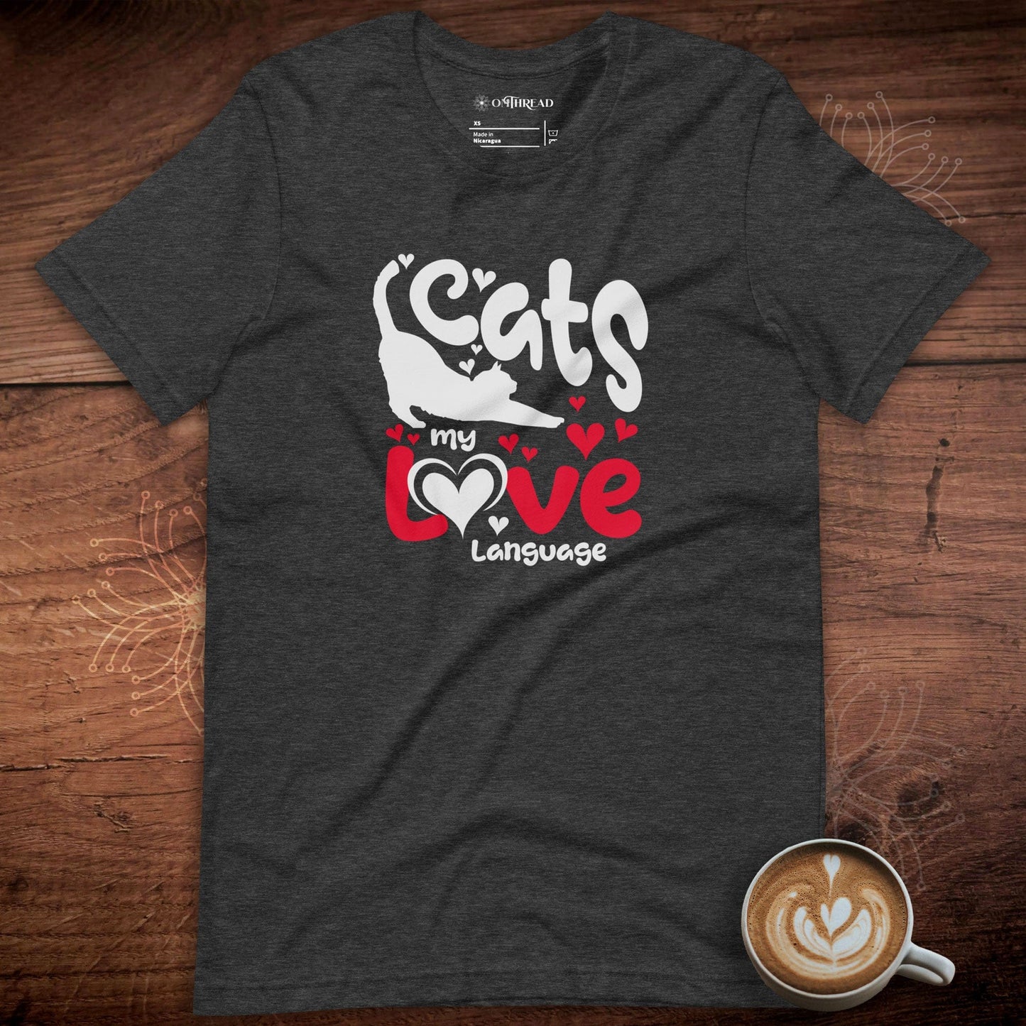 OMThread dark gray t-shirt featuring a bold graphic design with the phrase "Cats My Love Language" in white and red letters. The text is decorated with heart accents, and a playful cat silhouette is integrated into the typography.