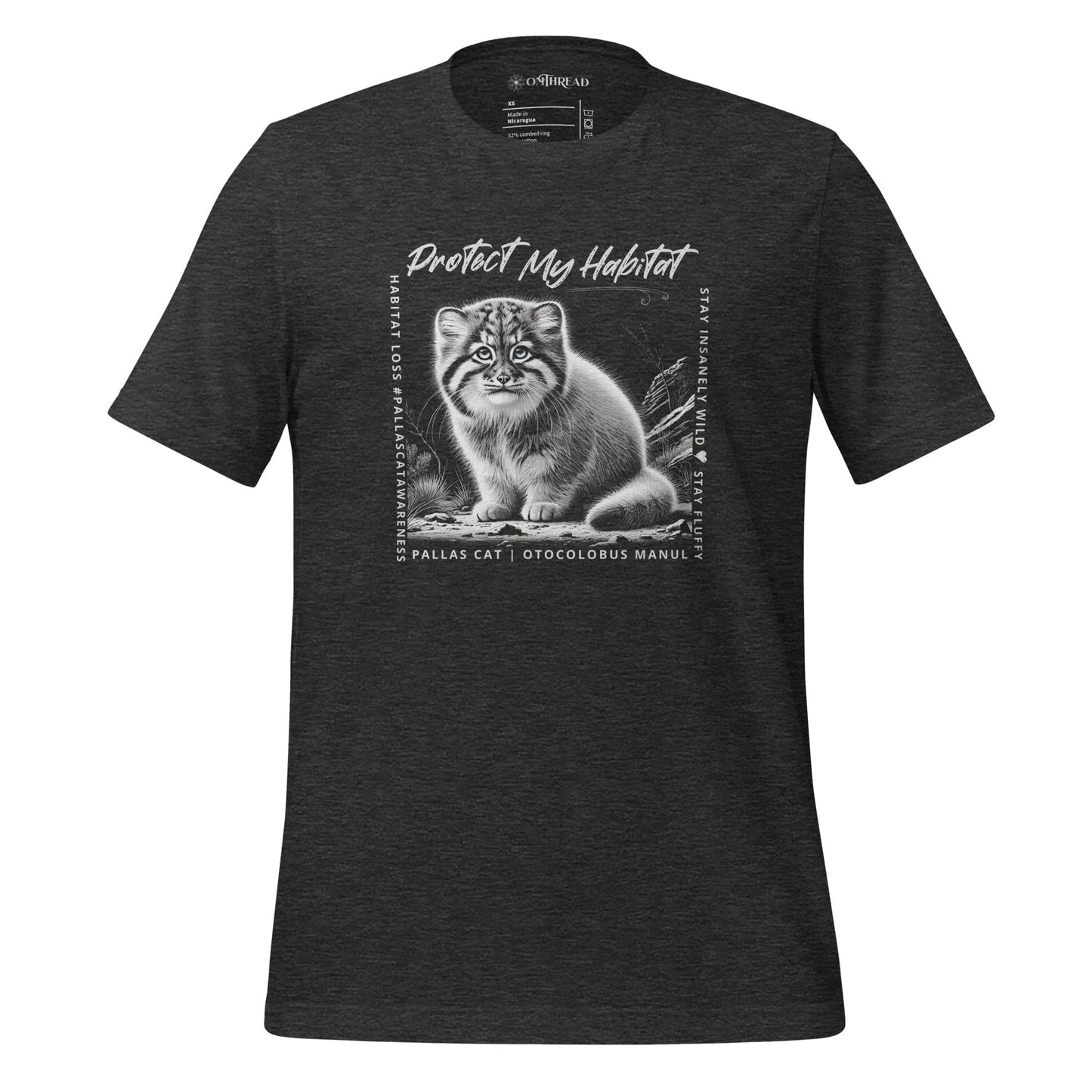 OMThread charcoal grey t-shirt featuring a black-and-white illustration of a Pallas cat kitten sitting in its natural habitat. The design includes the phrase "Protect My Habitat" at the top, with additional text on the sides reading "Habitat Loss • Pallas Cat Awareness" and "Stay Insane • Stay Wild • Stay Fluffy." The bottom text reads "Pallas Cat | Otocolobus Manul."