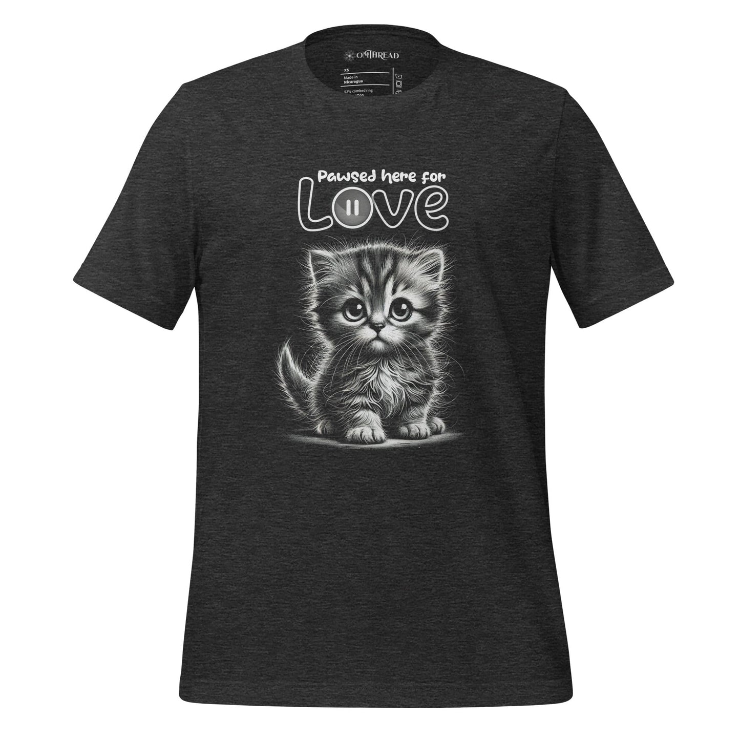 OMThread dark gray t-shirt featuring a black and white illustration of a fluffy kitten with large expressive eyes. Above the kitten, the phrase "Pawsed Here for Love" is written in a playful font, with the word "Love" incorporating a pause button symbol.