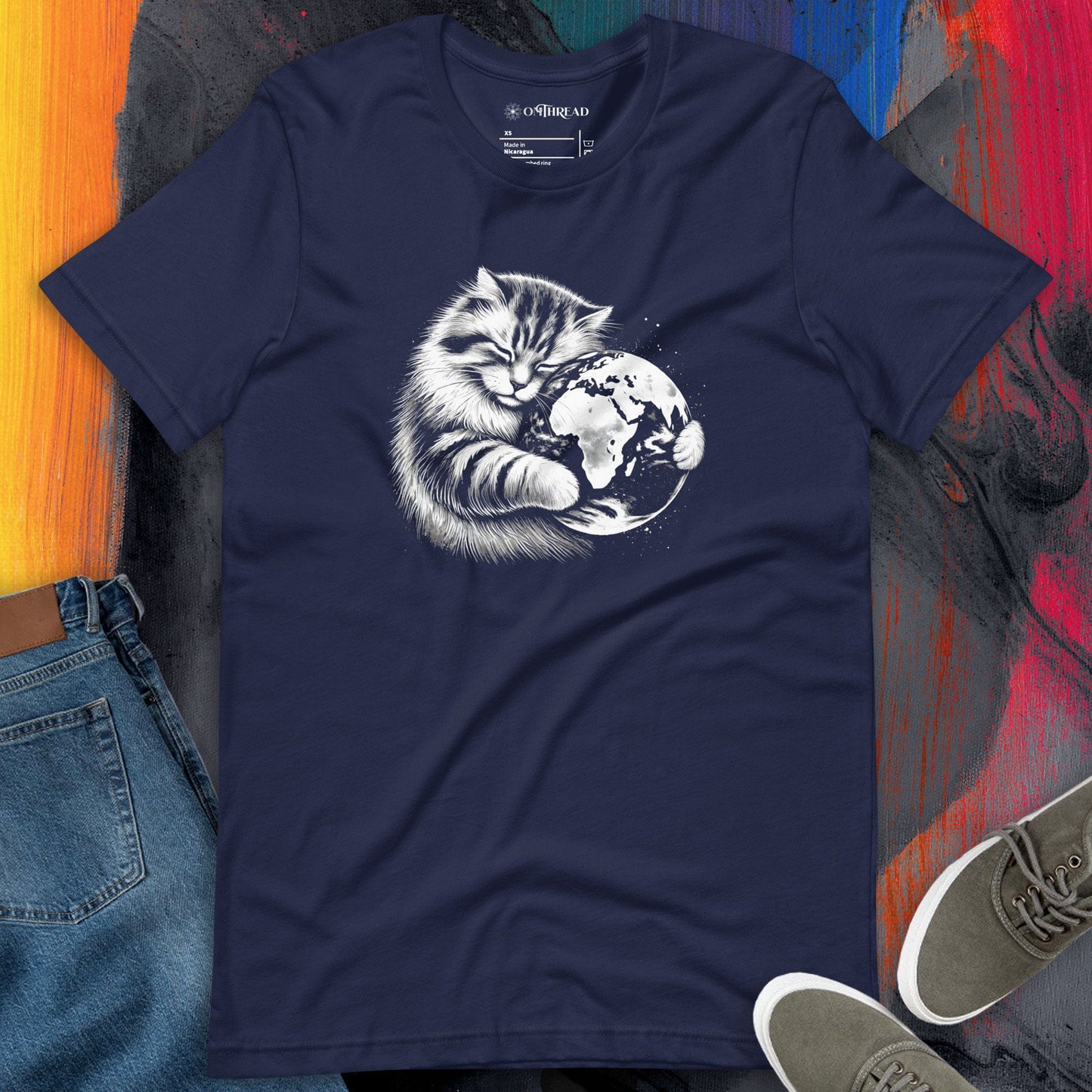 Navy blue t-shirt featuring a detailed illustration of a fluffy cat peacefully hugging planet Earth.