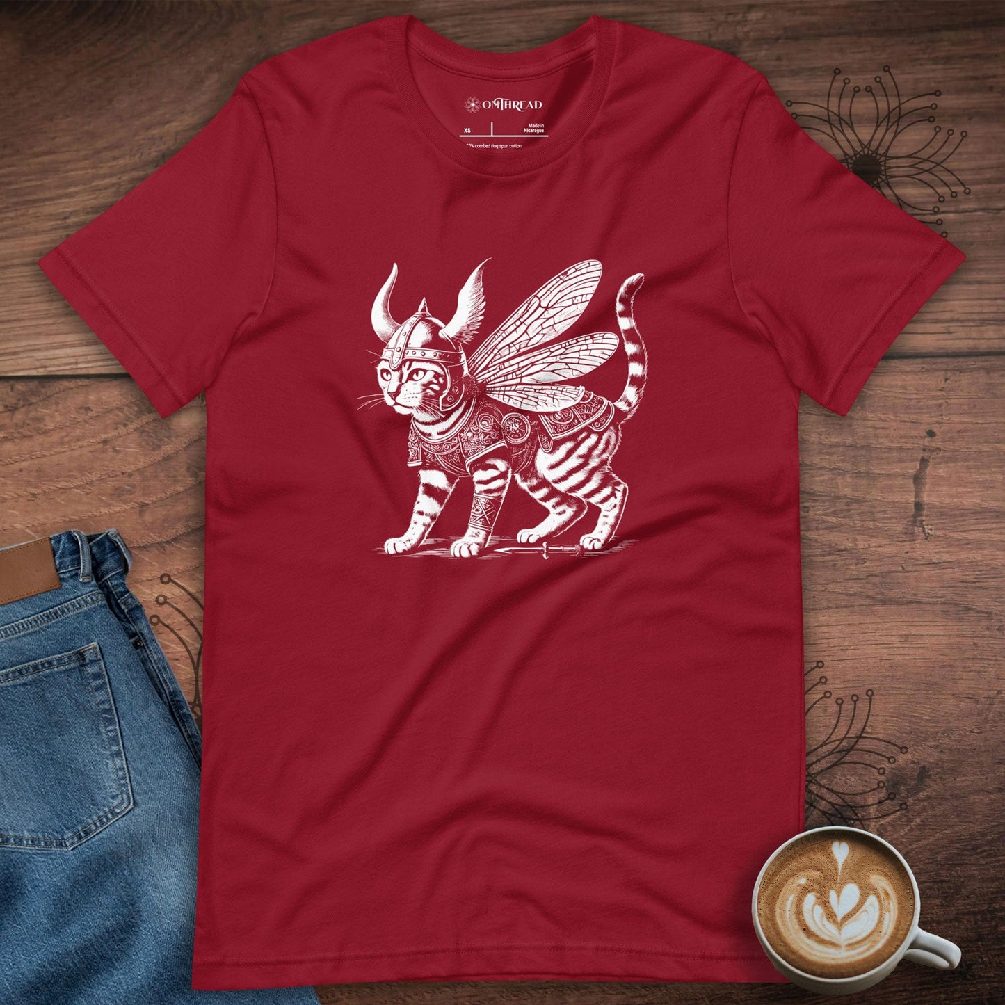 OMThread red t-shirt featuring a highly detailed illustration of a Viking warrior cat with insect-like wings, wearing intricate armor and a horned helmet. The feline stands confidently, exuding strength and mystery.