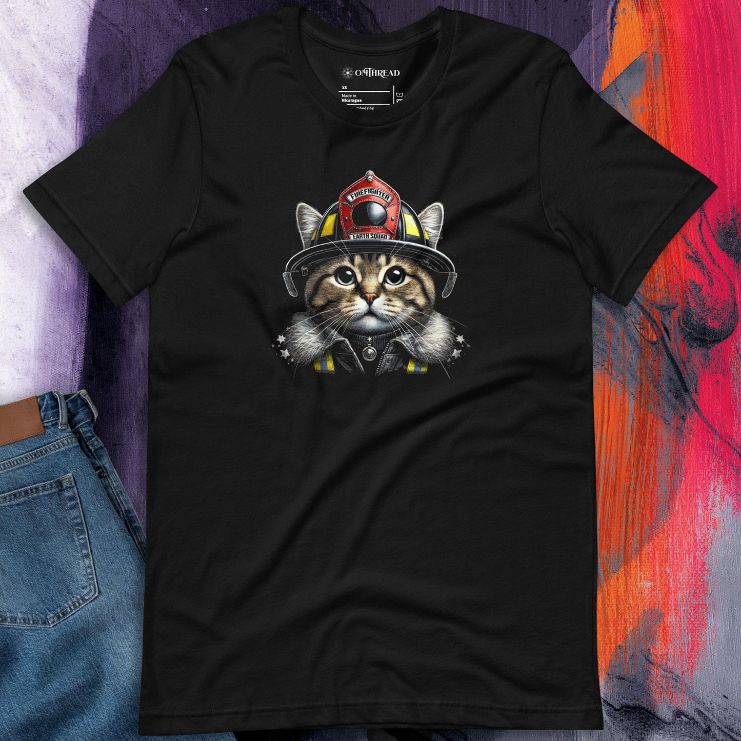OMThread firefighter cat black t-shirt featuring a detailed illustration of a cat wearing a firefighter helmet labeled "Earth Squad." The design highlights bravery and environmental responsibility.