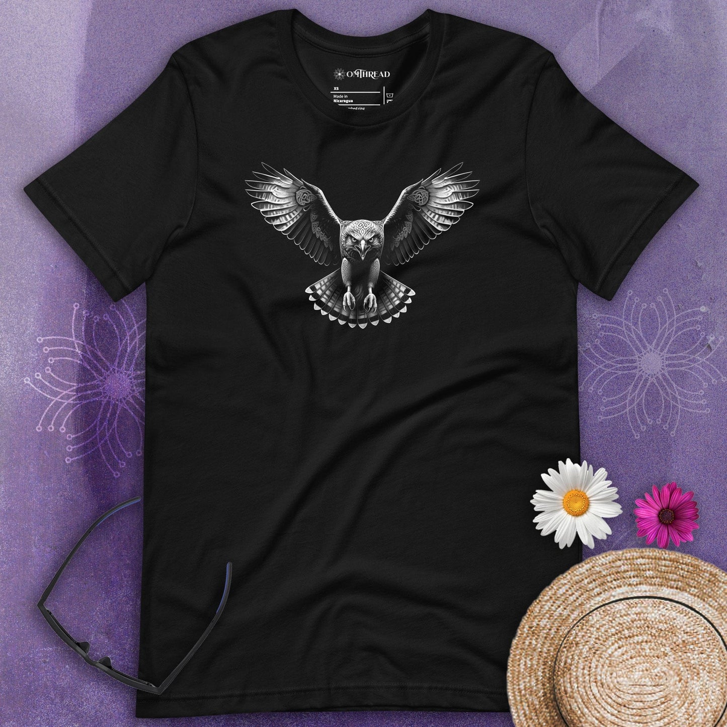 OMTHREAD black t-shirt with grayscale illustration of a hawk in mid-flight, wings spread wide, talons extended, and intricate feather details