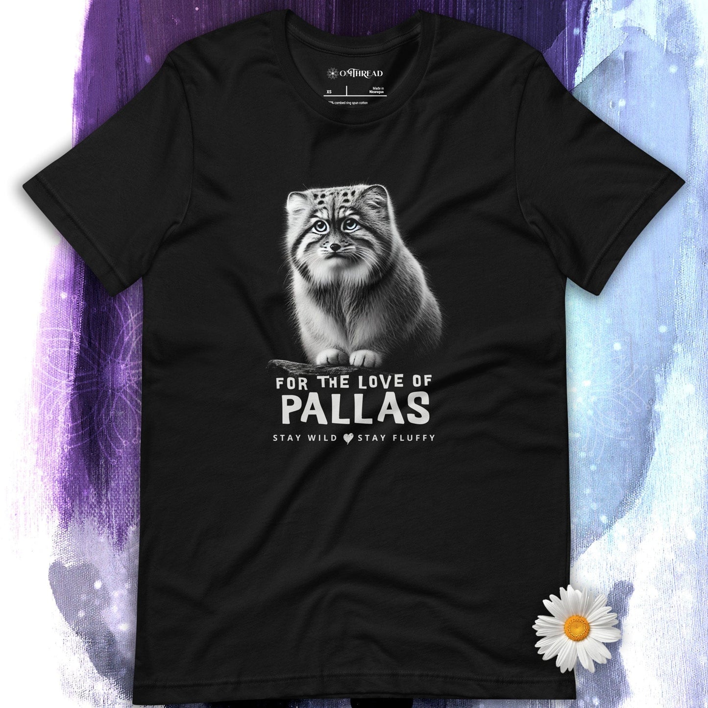 OMThread Black t-shirt featuring a detailed illustration of a Pallas cat sitting on a branch. The design includes bold text that reads "For the Love of Pallas" with the phrase "Stay Wild Stay Fluffy" underneath. The artwork is monochromatic with soft shading.