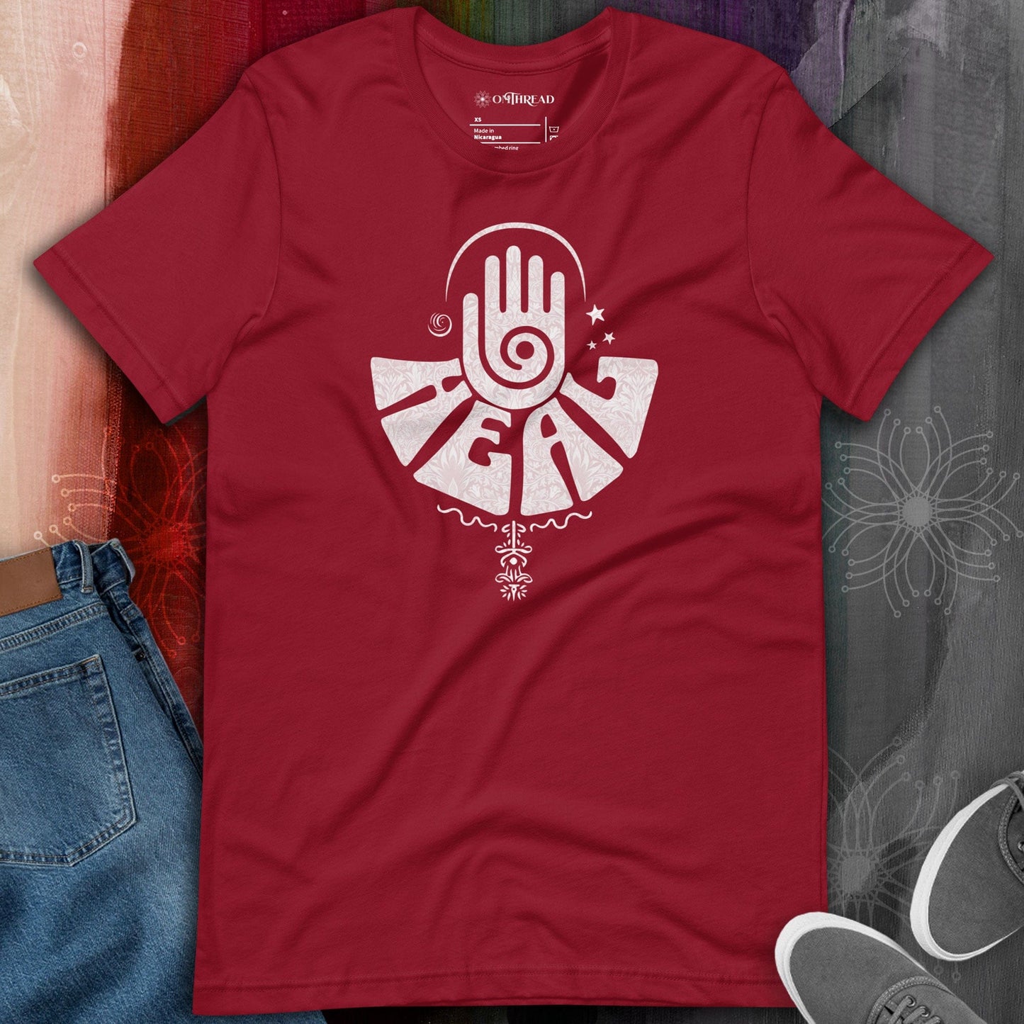 OMTHREAD red t-shirt featuring a white healing hand design with a spiral palm symbol and intricate patterns, representing energy healing and spiritual balance.