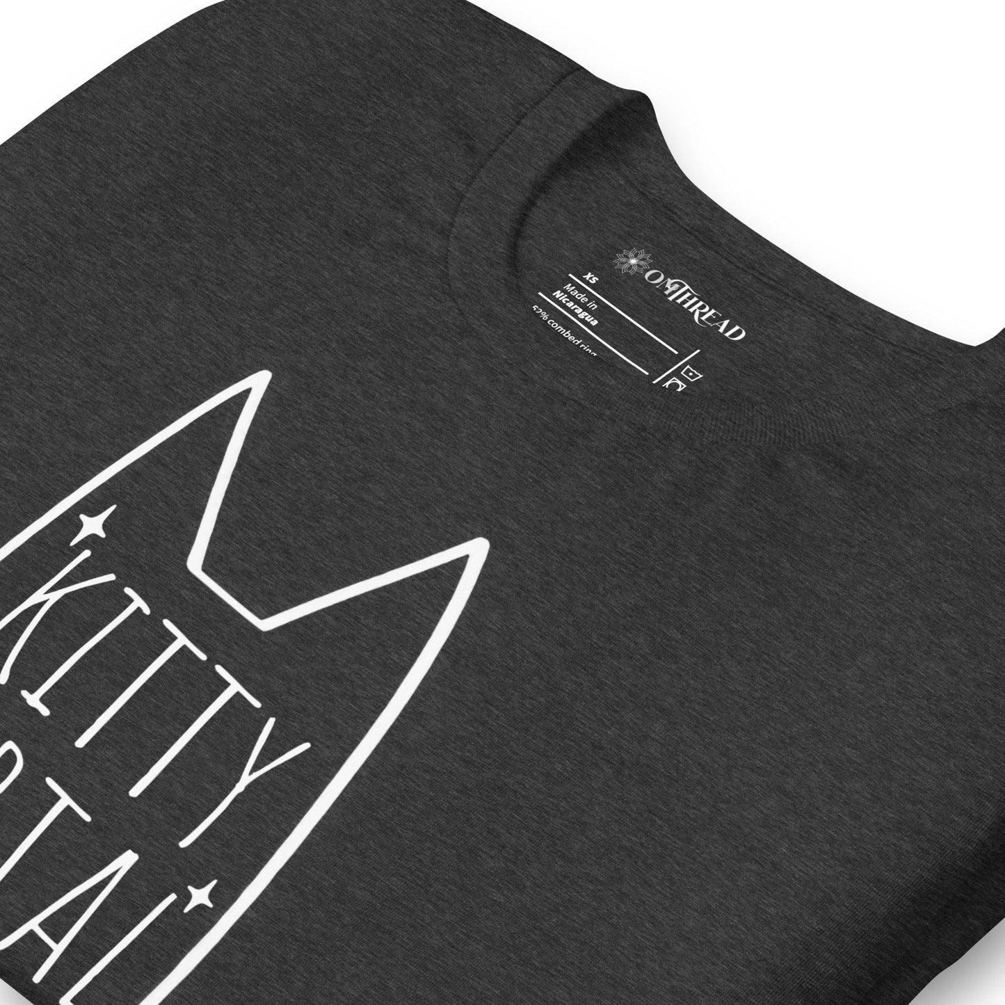 OMTHREAD dark gray t-shirt featuring a minimalist white cat outline with pointed ears, sparkling accents, and the text "Kitty Portal - Doorway to Magic" in a handwritten-style font.