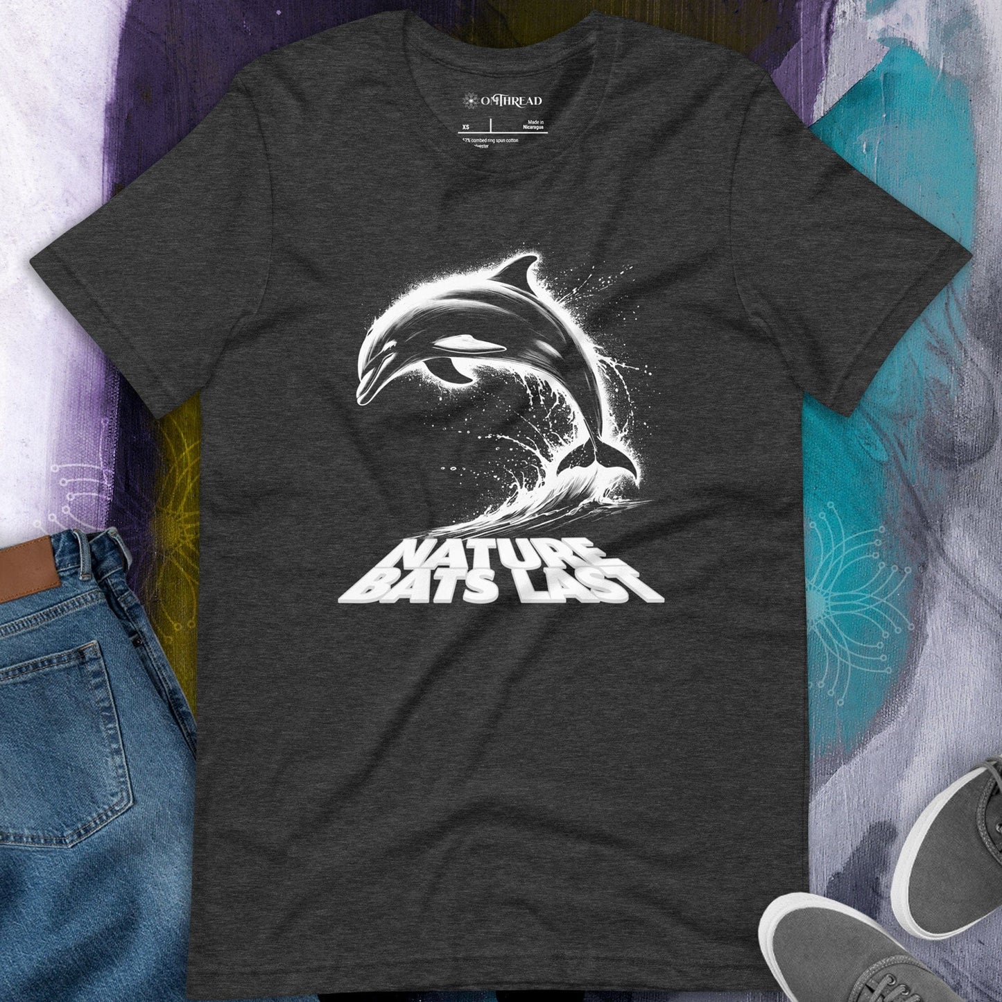 OMTHREAD dark grey heather t-shirt featuring a dynamic black and white illustration of a dolphin leaping from ocean waves with the text "Nature Bats Last" in bold typography.