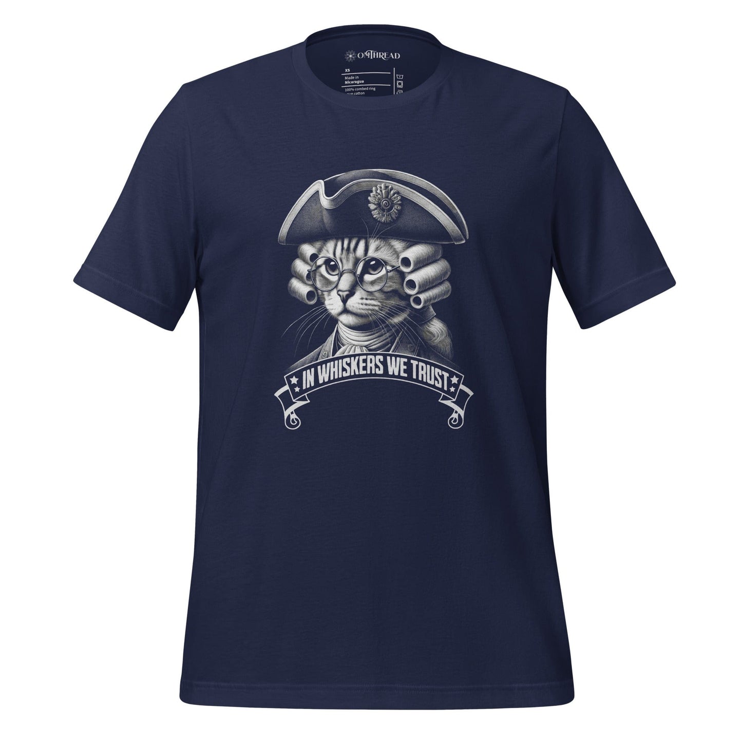 OMTHREAD navy t-shirt featuring a detailed cat illustration dressed in colonial attire, wearing a tricorn hat, glasses, and a powdered wig. The design includes the phrase 'In Whiskers We Trust' in a bold banner.