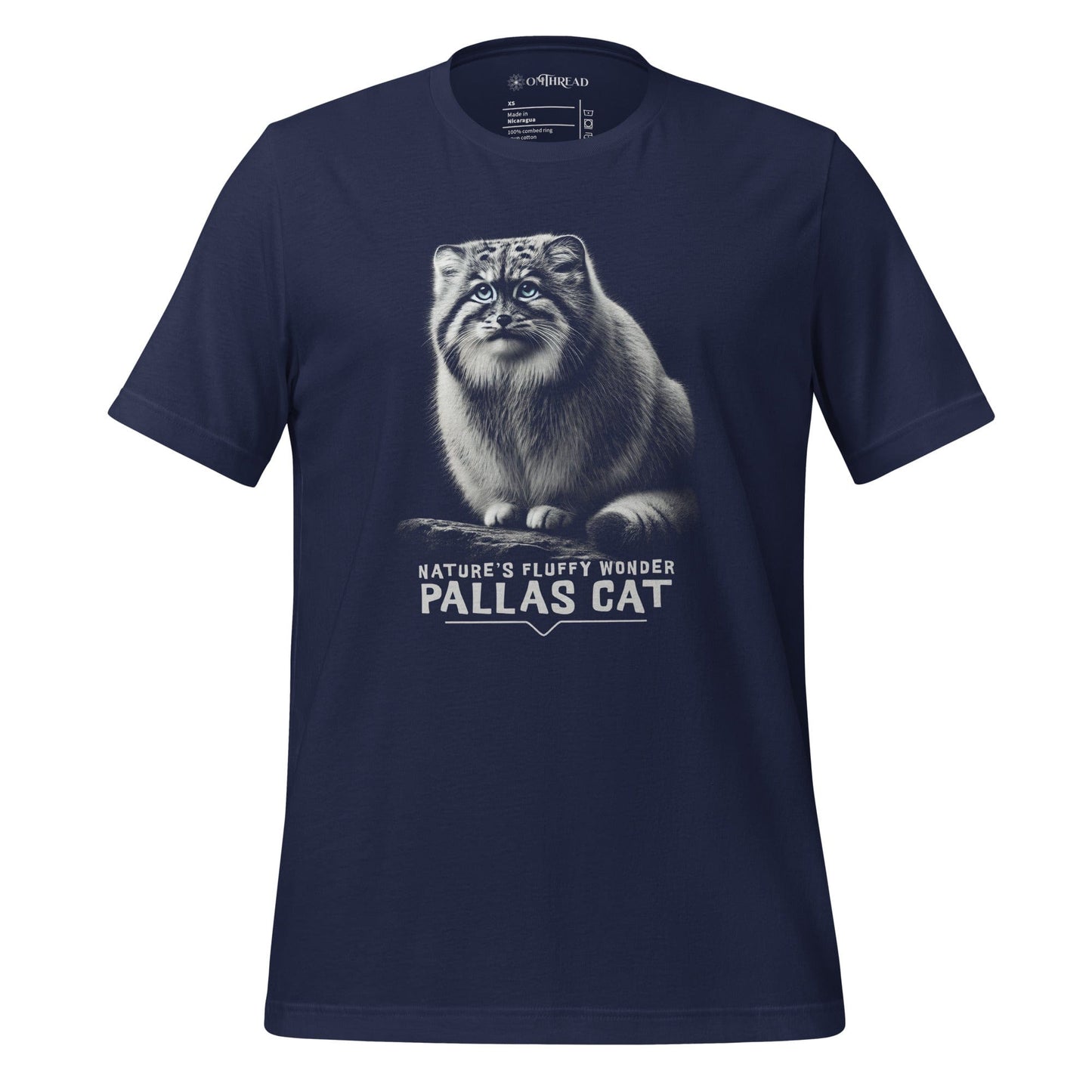 OMThread navy t-shirt featuring a detailed black-and-white illustration of a Pallas cat with piercing blue eyes and dense fur. Below the image, "Nature’s Fluffy Wonder Pallas Cat" is written in bold, modern typography.