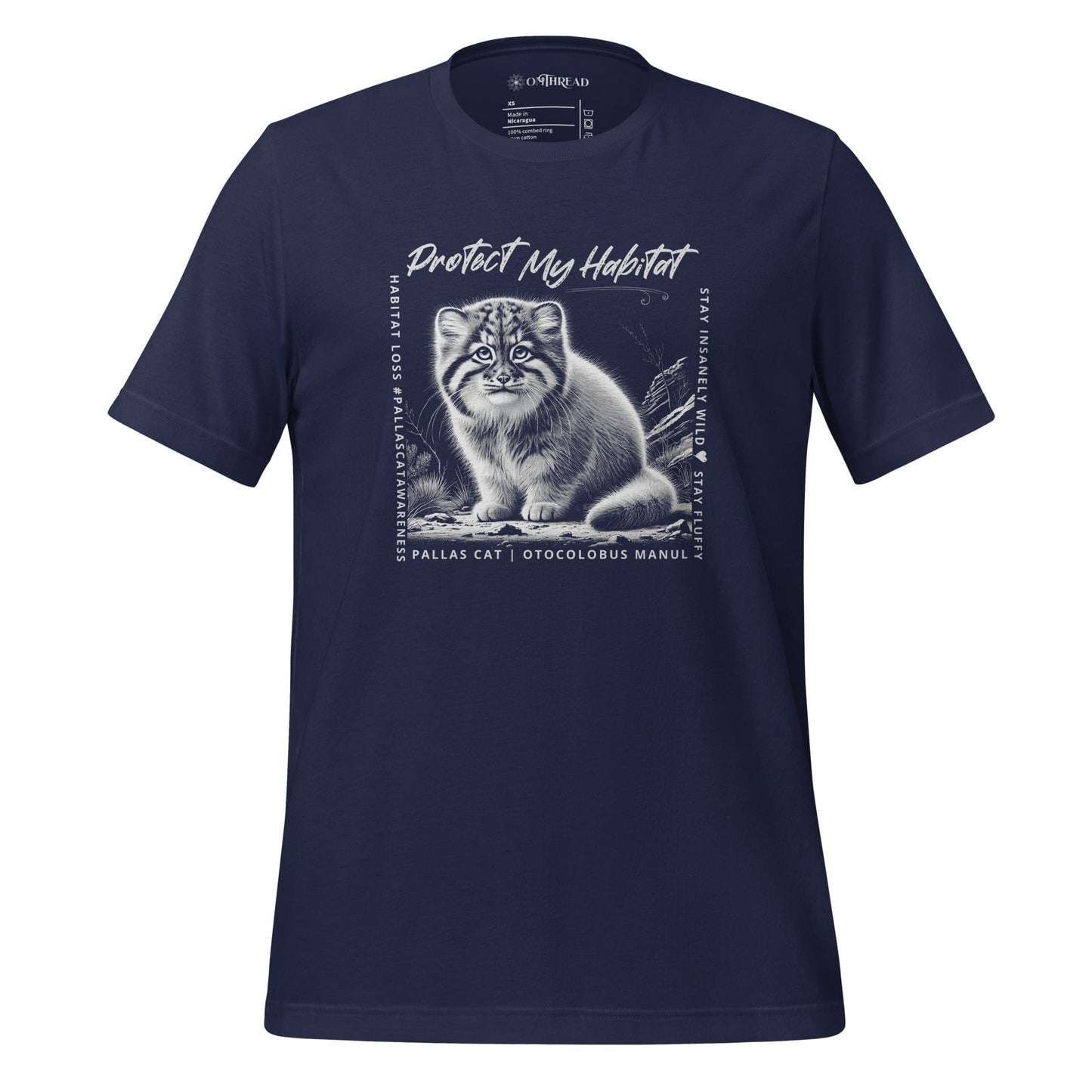 OMThread navy blue t-shirt featuring a black-and-white illustration of a Pallas cat kitten sitting in its natural habitat. The design includes the phrase "Protect My Habitat" at the top, with additional text on the sides reading "Habitat Loss • Pallas Cat Awareness" and "Stay Insane • Stay Wild • Stay Fluffy." The bottom text reads "Pallas Cat | Otocolobus Manul."