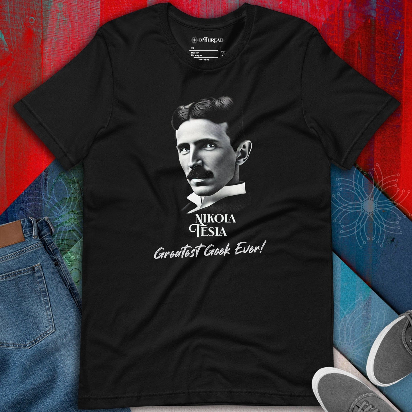 OMTHREAD Nikola Tesla Greatest Geek Ever Black Tee featuring a portrait of Nikola Tesla and the phrase "Greatest Geek Ever"