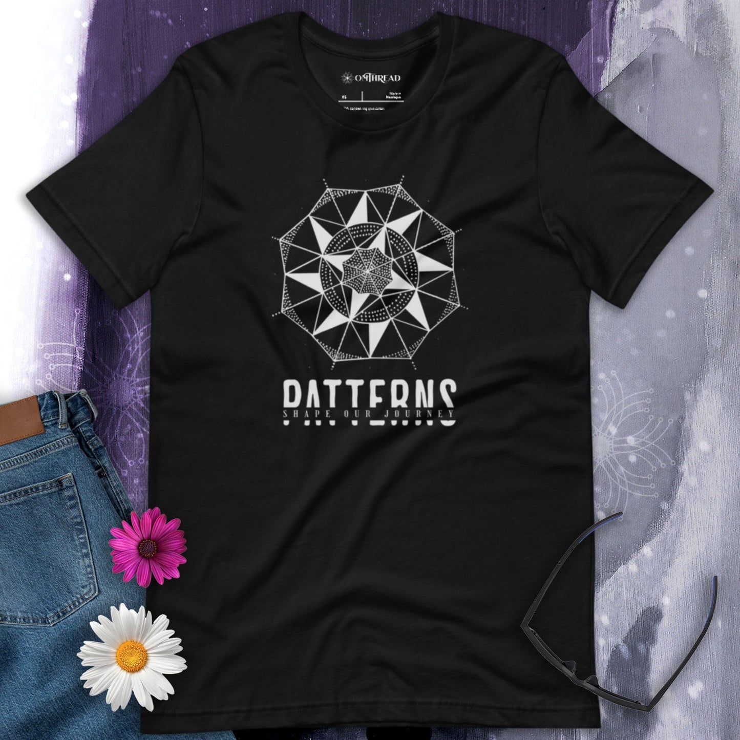 OMTHREAD black t-shirt with white geometric mandala design and "Patterns Shape Our Journey" text.