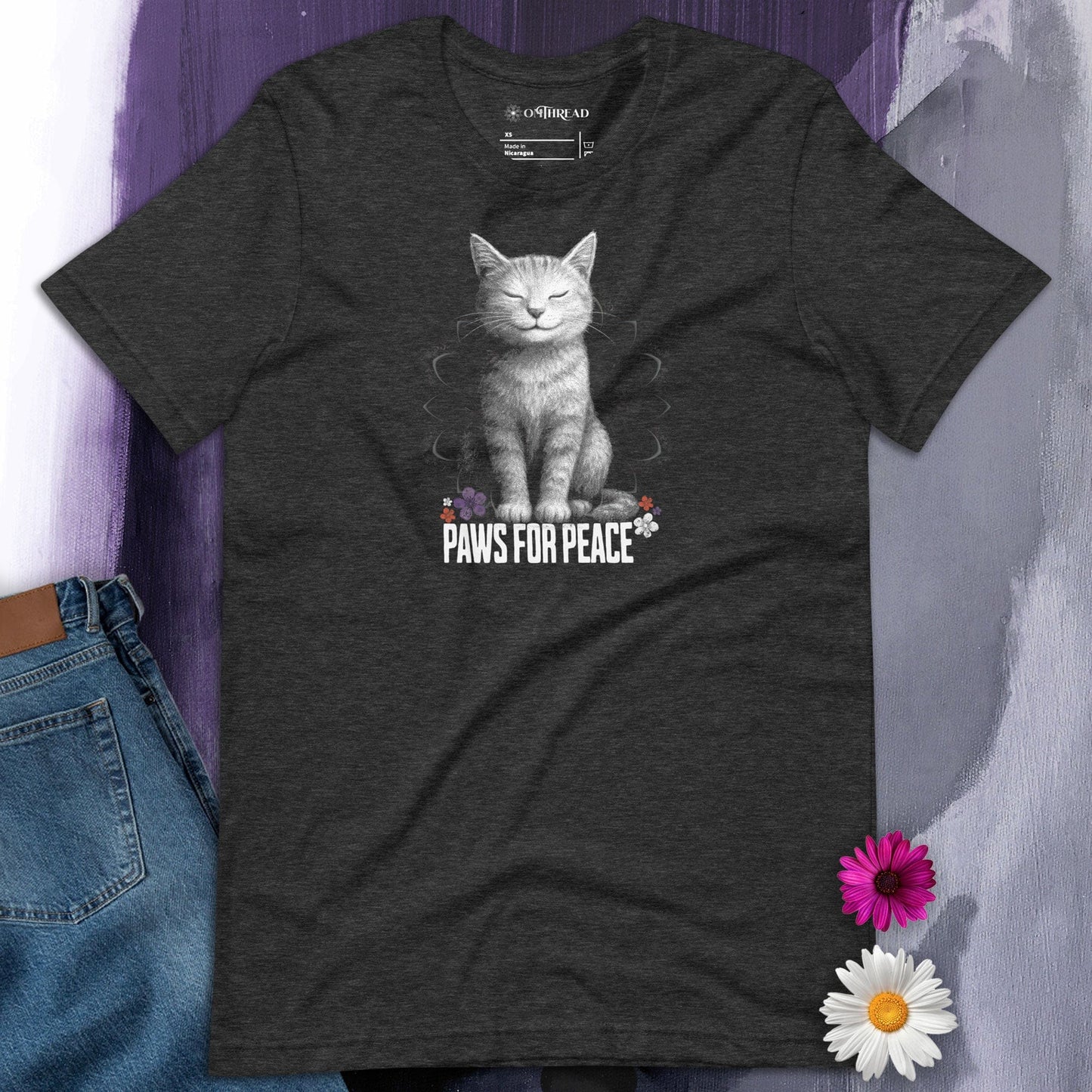 Dark gray unisex t-shirt with a lifelike illustration of a peaceful smiling cat sitting above the text Paws for Peace