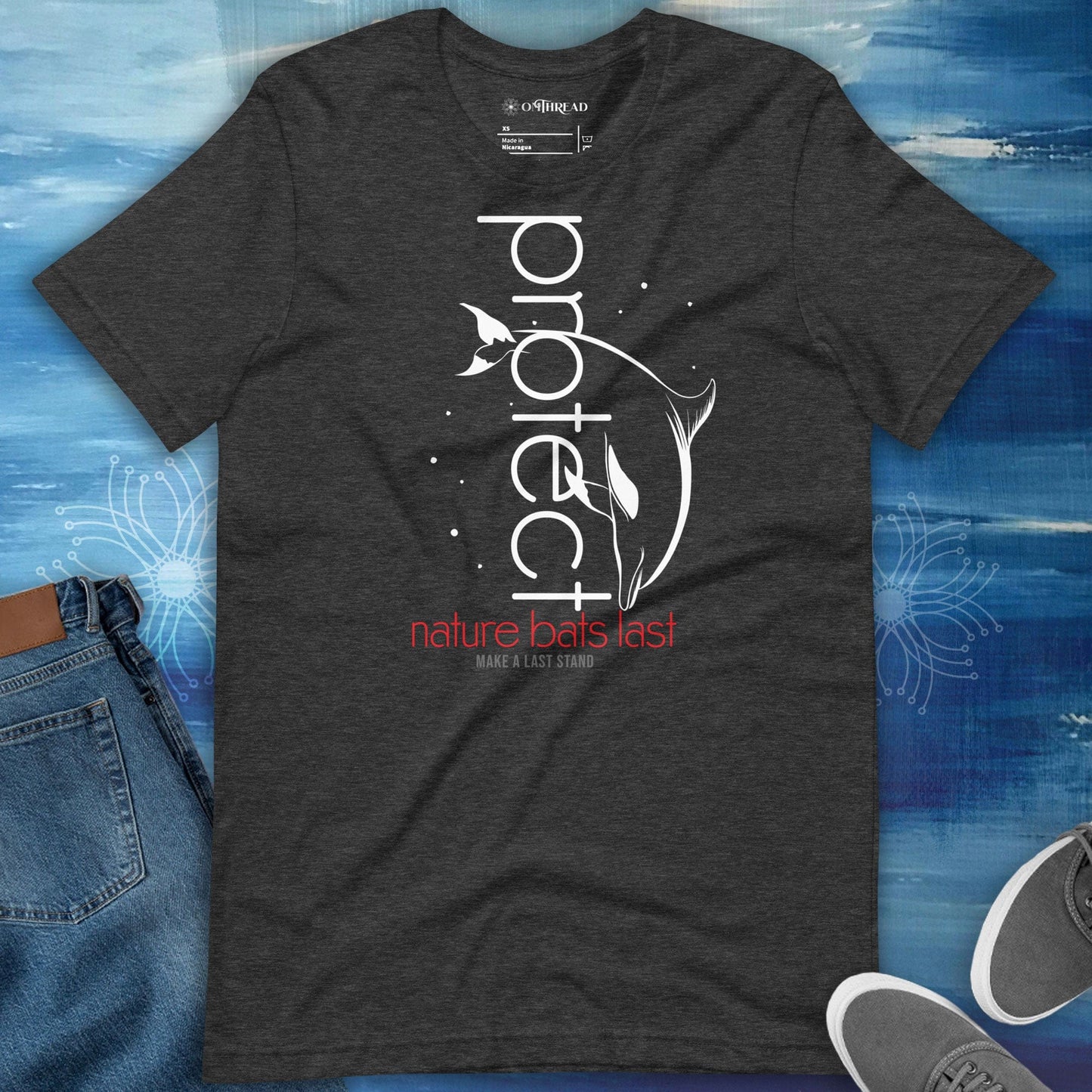 OMTHREAD dark grey heather t-shirt featuring a white dolphin illustration with the word "Protect" in vertical text and "Nature Bats Last" in red and "Make a Last Stand" below.