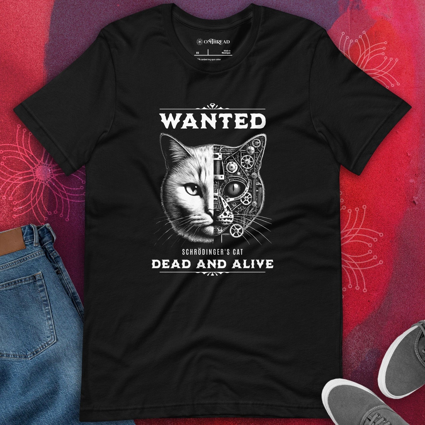 OMThread Black Schrödinger's Cat T-Shirt featuring 'WANTED' text above and 'DEAD AND ALIVE' below. The cat's face is half-realistic, half-mechanical with gears and circuits.