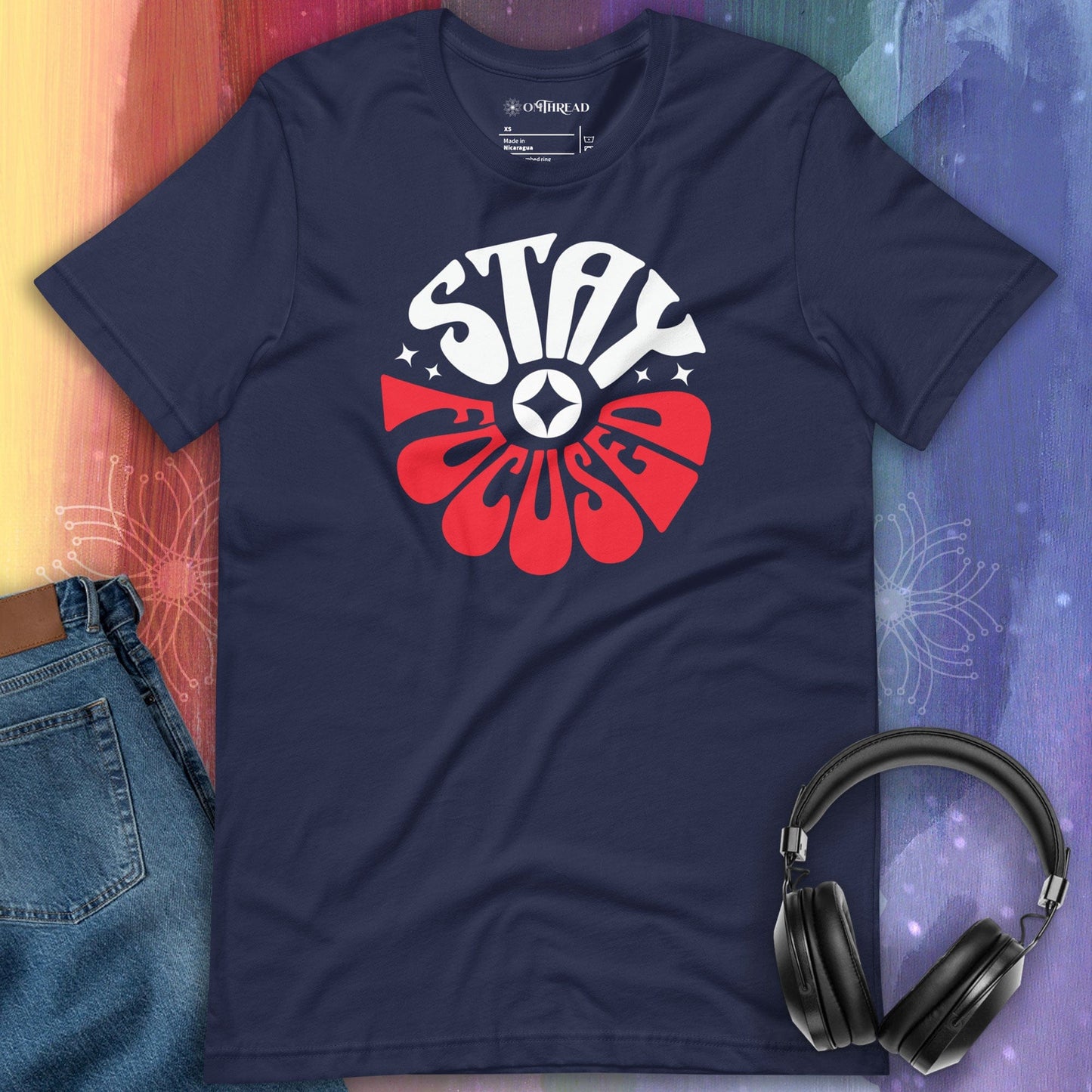OMTHREAD Navy t-shirt Stay Focused Inspiring Achiever Tee for Go-Getters: The design features bold and dynamic typography with the words "STAY FOCUSED" prominently displayed in large, stylized letters. The word "STAY" is in white, while "FOCUSED" is in red, with a circular symbol in the center.