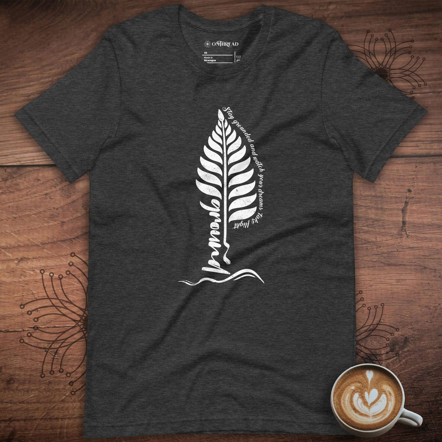 OMTHREAD Stay Grounded and Let Your Dreams Take Flight , Dark Grey Tee, Motivational design with a fern leaf and the text "Stay Grounded and Let Your Dreams Take Flight"