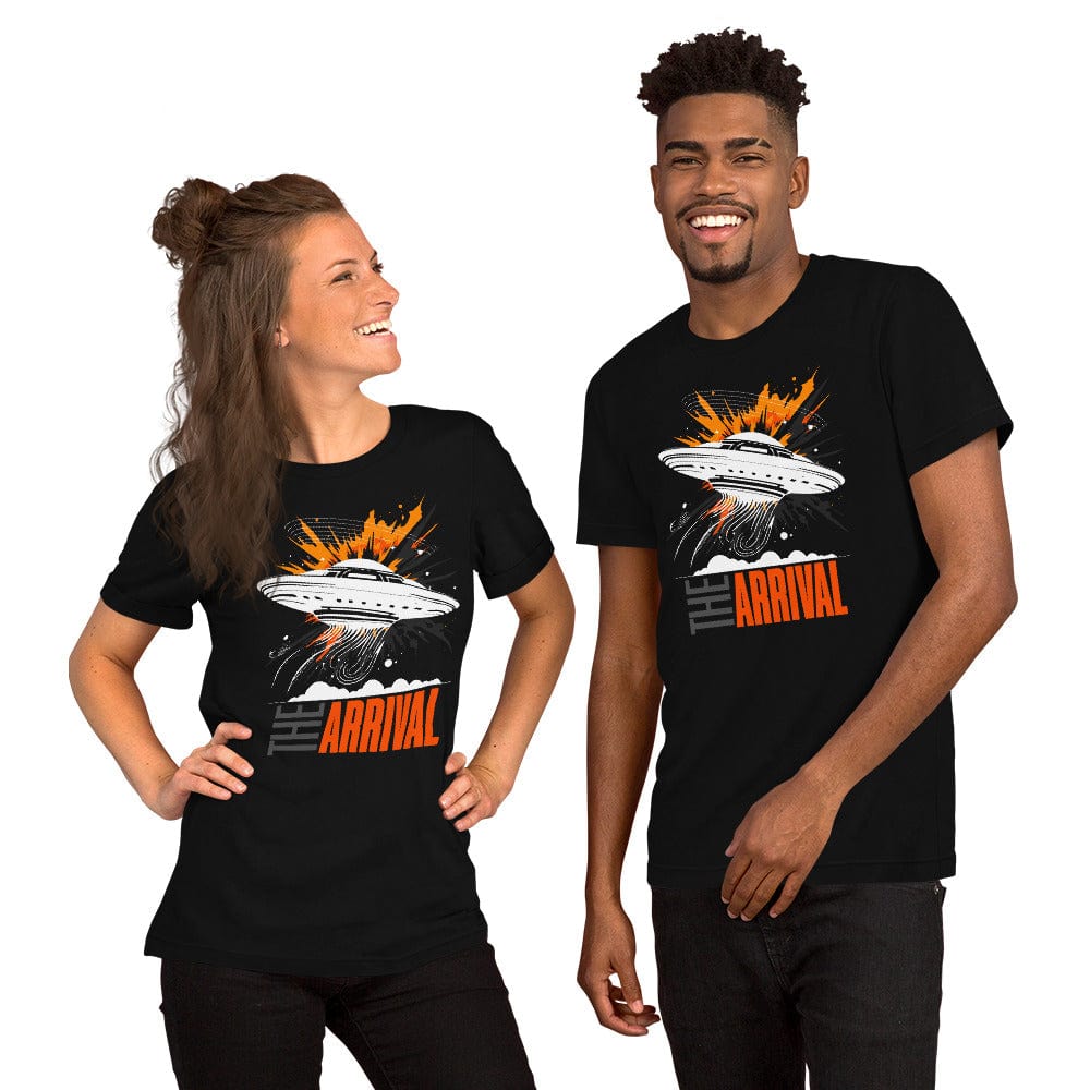 Man and woman wearing black t-shirt showcasing a bold design of a UFO emitting glowing beams, surrounded by explosive orange accents, clouds, and dynamic motion lines, with the text, THE ARRIVAL in contrasting gray and orange, blending sci-fi and graphic art.