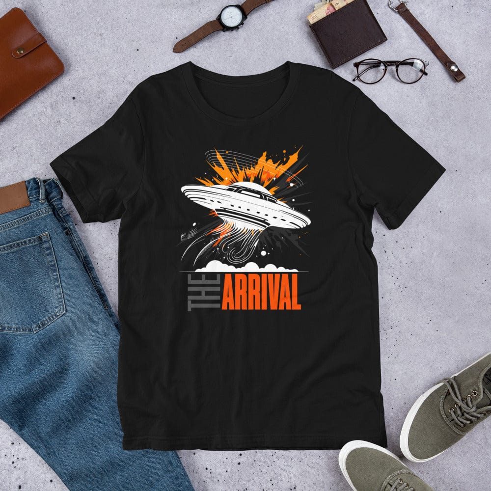 Black t-shirt showcasing a bold design of a UFO emitting glowing beams, surrounded by explosive orange accents, clouds, and dynamic motion lines, with the text, THE ARRIVAL in contrasting gray and orange, blending sci-fi and graphic art.