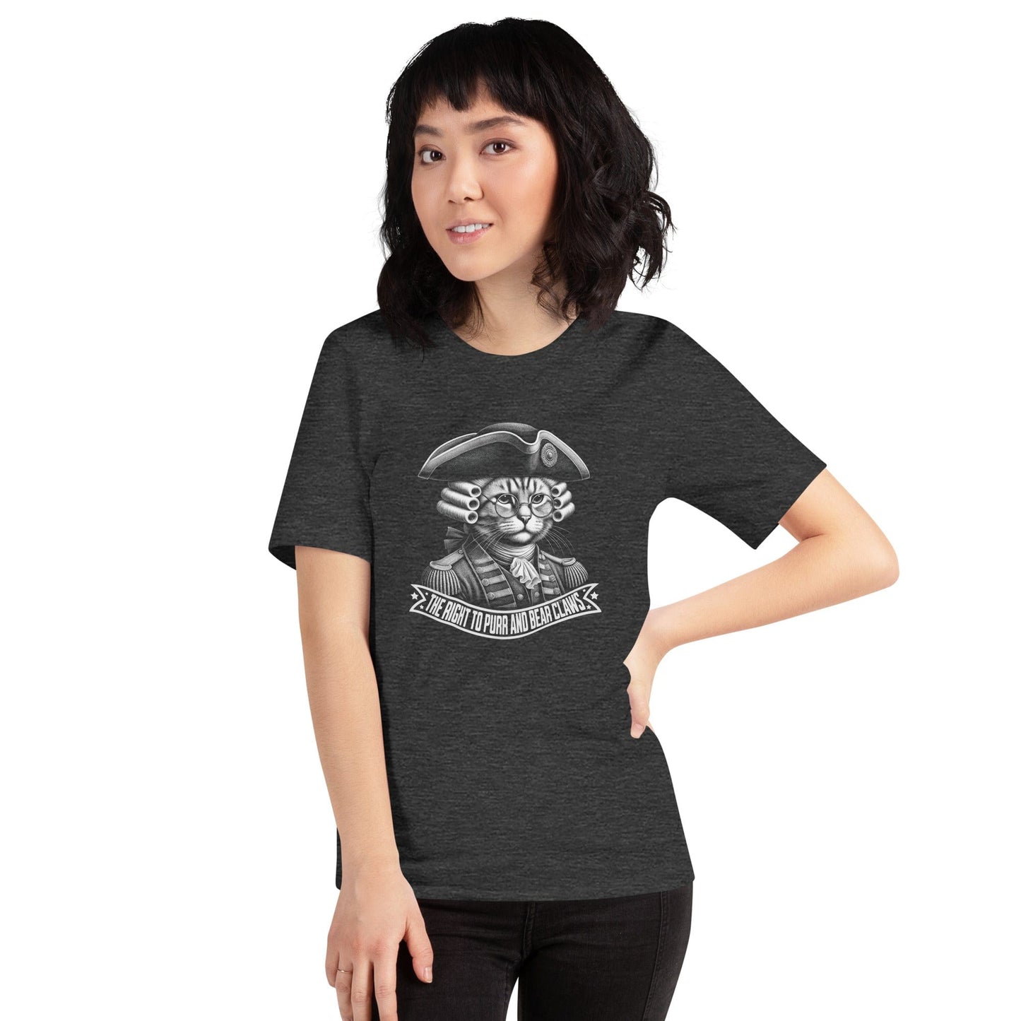 Woman wearing a dark gray t-shirt featuring a colonial-style cat in 18th-century revolutionary attire, complete with a powdered wig and glasses. The banner below reads, The Right to Purr and Bear Claws in bold lettering, surrounded by stars.