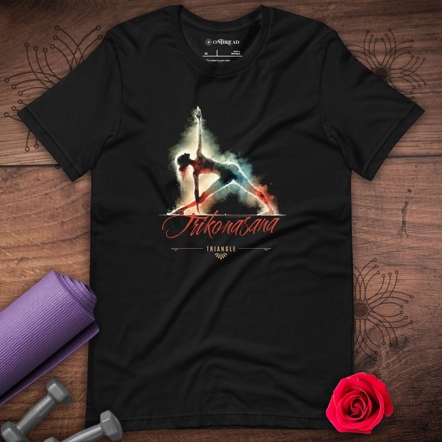 OMThread black t-shirt featuring a watercolor-style illustration of a person in the Trikonasana yoga pose, also known as the Triangle Pose, with artistic smoke effects and stylized text below.