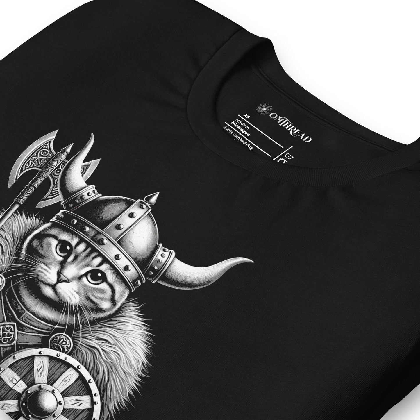 Black t-shirt featuring a Viking cat warrior wearing a horned helmet, fur cloak, and armor, holding an axe and shield. The word 'VALHALLA' is displayed below.