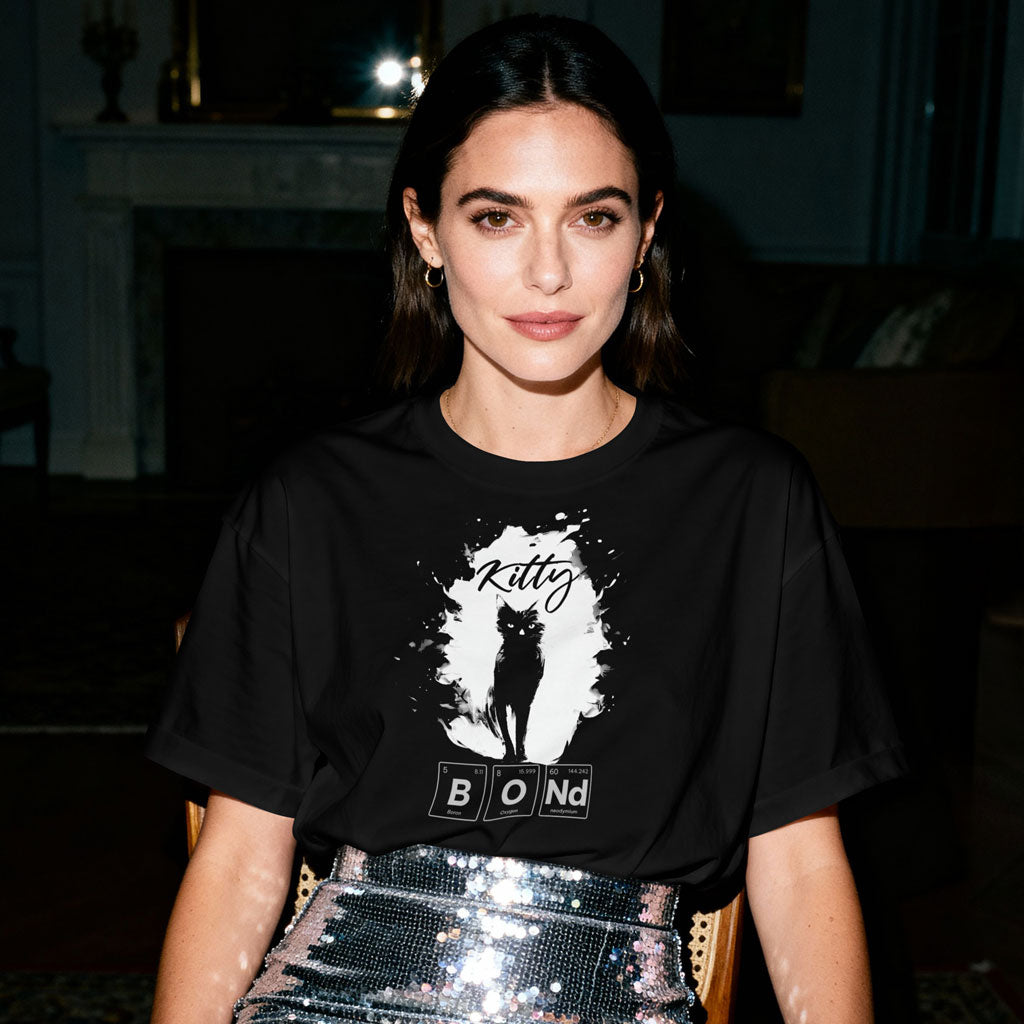 OMThread black t-shirt promoting the Periodic Table Elemental Cats collection, featuring a minimalist cat silhouette graphic worn by a model indoors