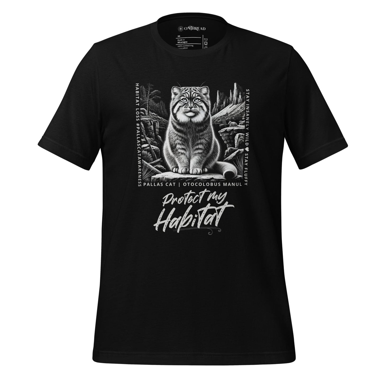 Black t-shirt featuring a detailed black-and-white illustration of a Pallas cat sitting in its natural habitat, surrounded by mountains and rocks. Text reads 'Protect My Habitat' with additional phrases like 'Habitat Loss Pallas Cat Awareness' and 'Stay Insanely Wild & Stay Fluffy'.