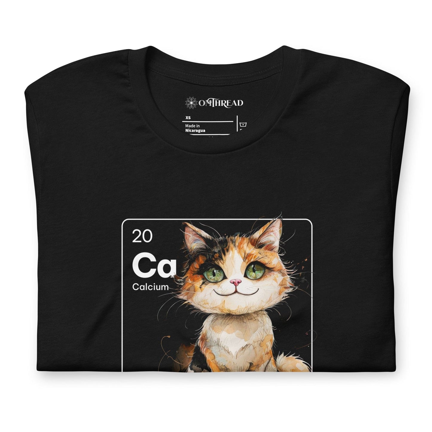 Black t-shirt featuring a periodic table-inspired design of a charming, illustrated calico cat within a square labeled 'Ca' for Calcium. Text below reads 'Cal-lico Charm