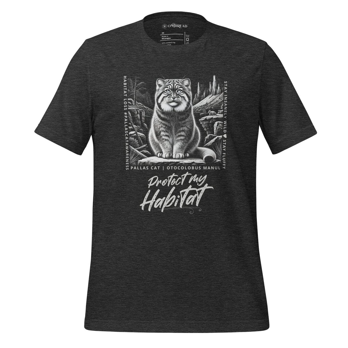 Dark gray t-shirt featuring a detailed black-and-white illustration of a Pallas cat sitting in its natural habitat, surrounded by mountains and rocks. Text reads 'Protect My Habitat' with additional phrases like 'Habitat Loss Pallas Cat Awareness' and 'Stay Insanely Wild & Stay Fluffy'.