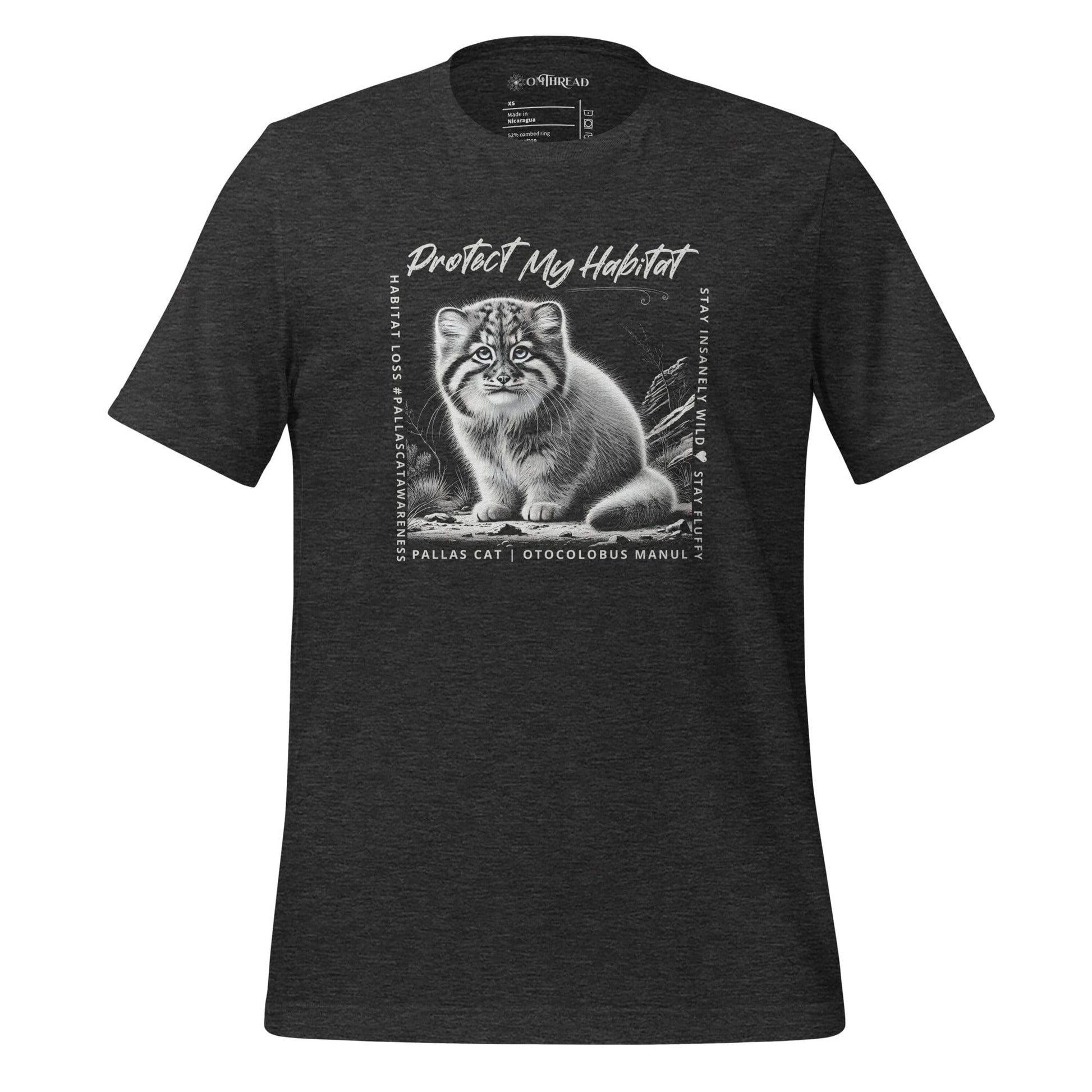 Charcoal grey t-shirt featuring a detailed black-and-white illustration of a Pallas Kitten sitting in its habitat. The design includes the phrase 'Protect My Habitat' at the top, with text on the sides reading 'Habitat Loss Pallas Cat Awareness' and 'Stay Insanely Wild & Stay Fluffy'. The bottom features 'Pallas Cat Otocolobus Manul' in clean typography