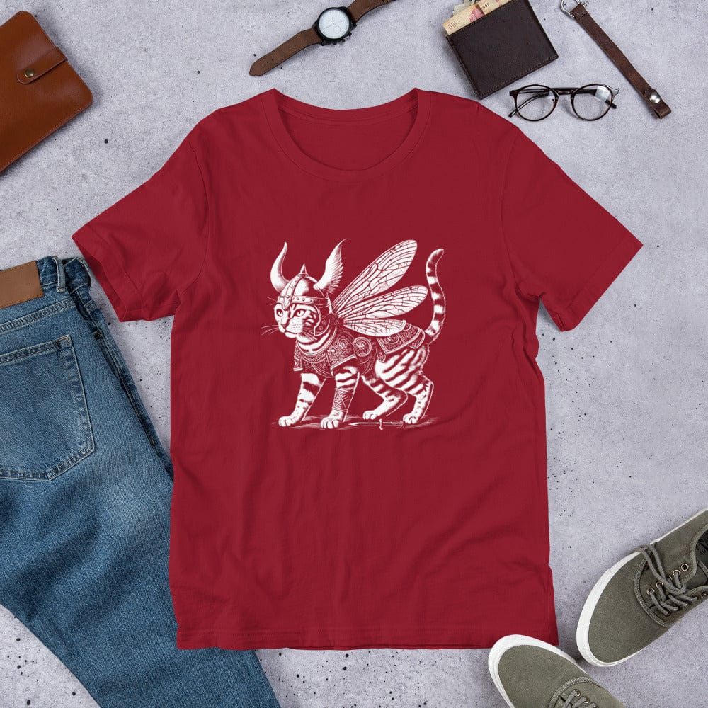 A red t-shirt featuring a detailed illustration of a cat dressed as a Viking warrior, complete with armor, horned helmet, and insect-like wings. The cat stands confidently with intricate linework and patterns enhancing the design.