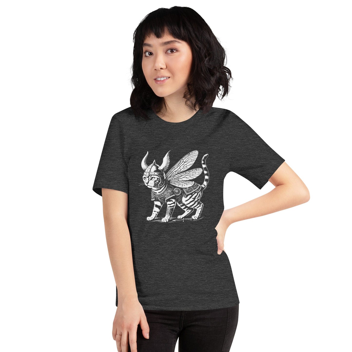 A woman wearing a dark gray t-shirt featuring a detailed illustration of a cat dressed as a Viking warrior, complete with armor, horned helmet, and insect-like wings. The cat stands confidently with intricate linework and patterns enhancing the design.