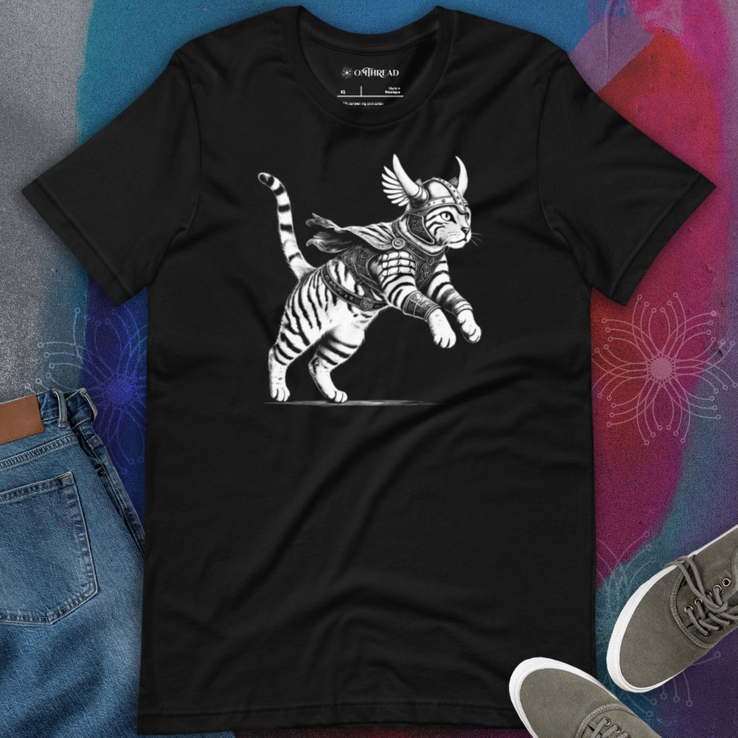 Black t-shirt featuring a detailed illustration of a Viking cat in armor with a horned helmet, a flowing cape, and feathered wings. The cat stands in an action-ready pose with intricate linework and shading.