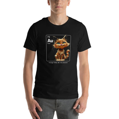 Man wearing a black t-shirt featuring an orange tabby cat sitting cheerfully inside a square design resembling a periodic table element. The square includes 'Au' for gold, the atomic number 79, and the text 'Orange Tabby In My Element' underneath.