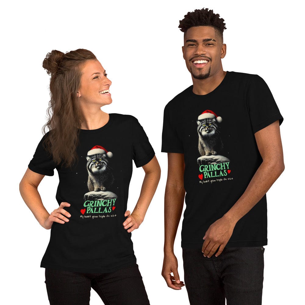 Man and woman  wearing black t-shirt featuring a Pallas cat wearing a Santa hat, sitting on a snowy rock with a grumpy expression. The text below reads 'GRINCHY PALLAS' in green and red, with the phrase 'My heart grew triple its size' underneath.