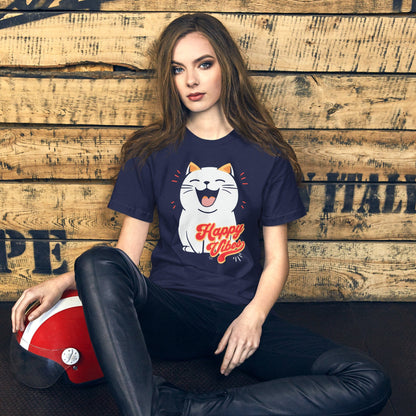 Woman wearing OMThread's 'Happy Vibes' t-shirt in navy blue, with a cute cartoon cat and retro 'Happy Vibes' text, set against a rustic wood background for a relaxed and joyful vibe.