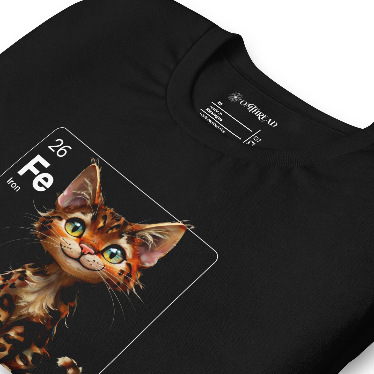 Black t-shirt with a periodic table-inspired design featuring a cute, illustrated Bengal cat within a square labeled 'Fe' for Iron. Text below reads 'Bengal In My Element'