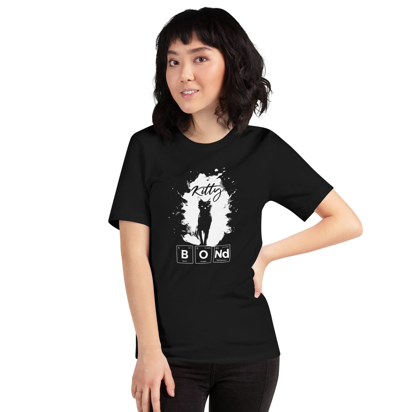 Woman wearing black t-shirt featuring a silhouette of a black cat within a white paint splatter design. Above the cat, the word 'Kitty' is written in cursive, and below, 'BOND' is spelled out using periodic table elements: Boron (B), Oxygen (O), and Neodymium (Nd).