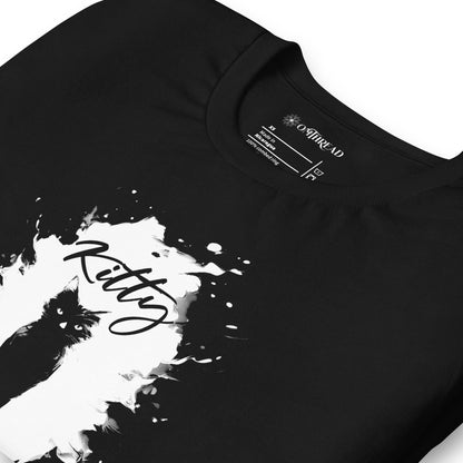 Black t-shirt featuring a silhouette of a black cat within a white paint splatter design. Above the cat, the word 'Kitty' is written in cursive, and below, 'BOND' is spelled out using periodic table elements: Boron (B), Oxygen (O), and Neodymium (Nd).